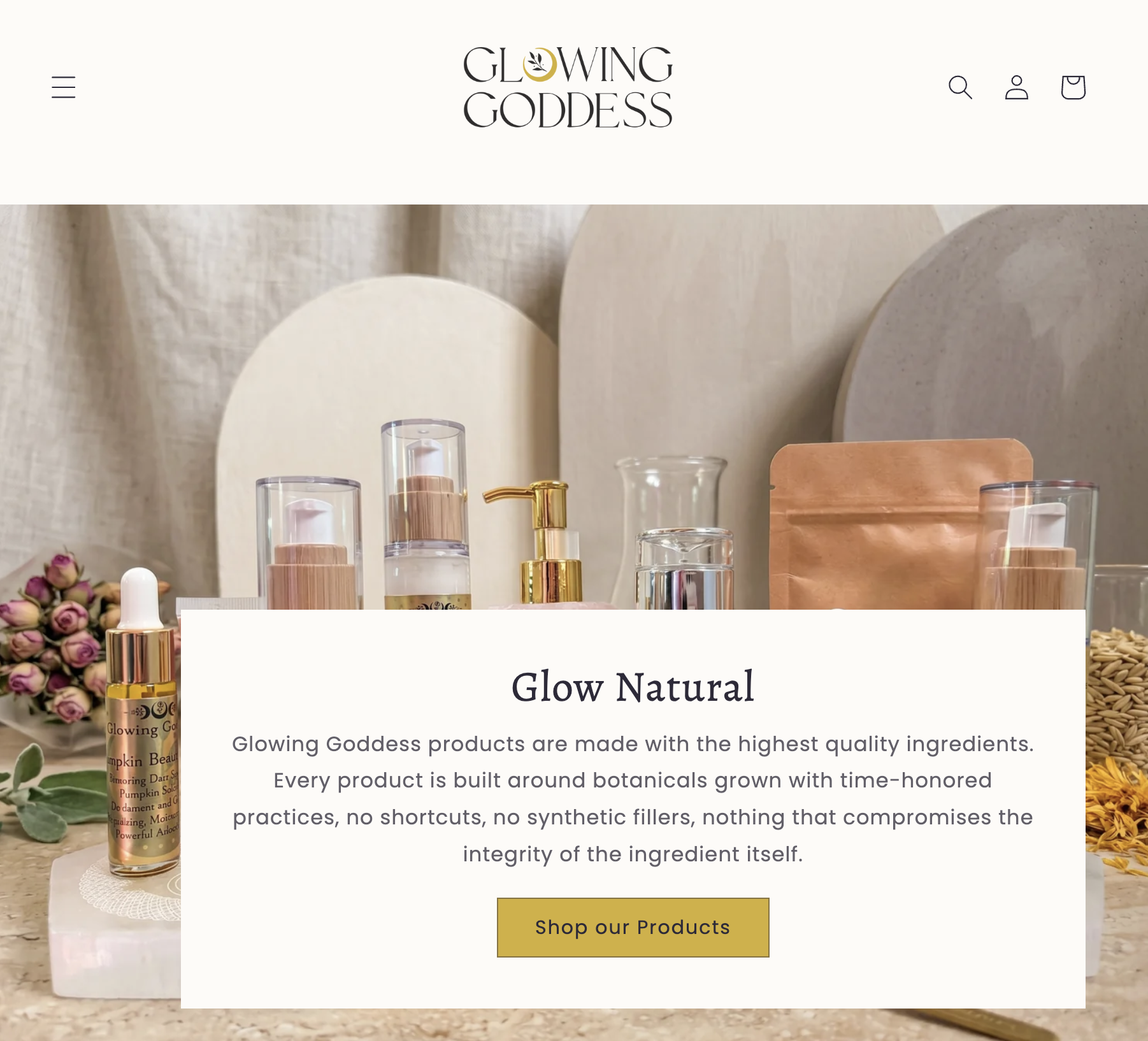 Homepage of Glowing Goddess skincare brand, featuring natural skincare products such as serums and oils on a wooden table with flowers and soft neutral background.