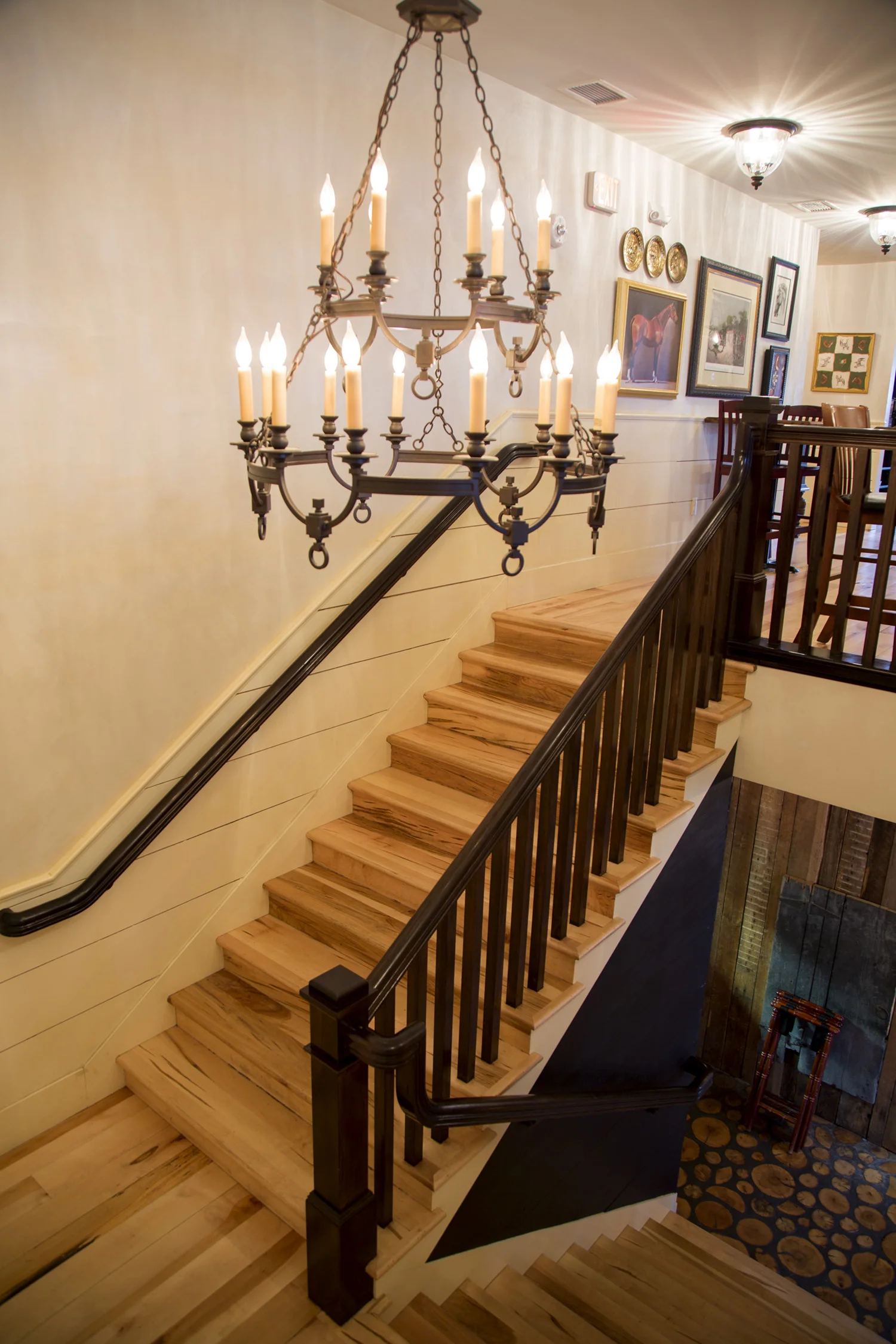 Balcony Return to the top of the old stairs and cross the walkway to the balcony. The stair railing was crafted by Northern Stair of Metamora. The balcony provides the best view of John Yarema's tree floor, made from live-edge cherry and red maple (all from the owner's property). John hand-cut and laid out the entire floor in a Dryden warehouse, numbered the pieces and reassembled them like a puzzle. The stair well from the balcony features more of Jean Lous Sauvat's artwork.