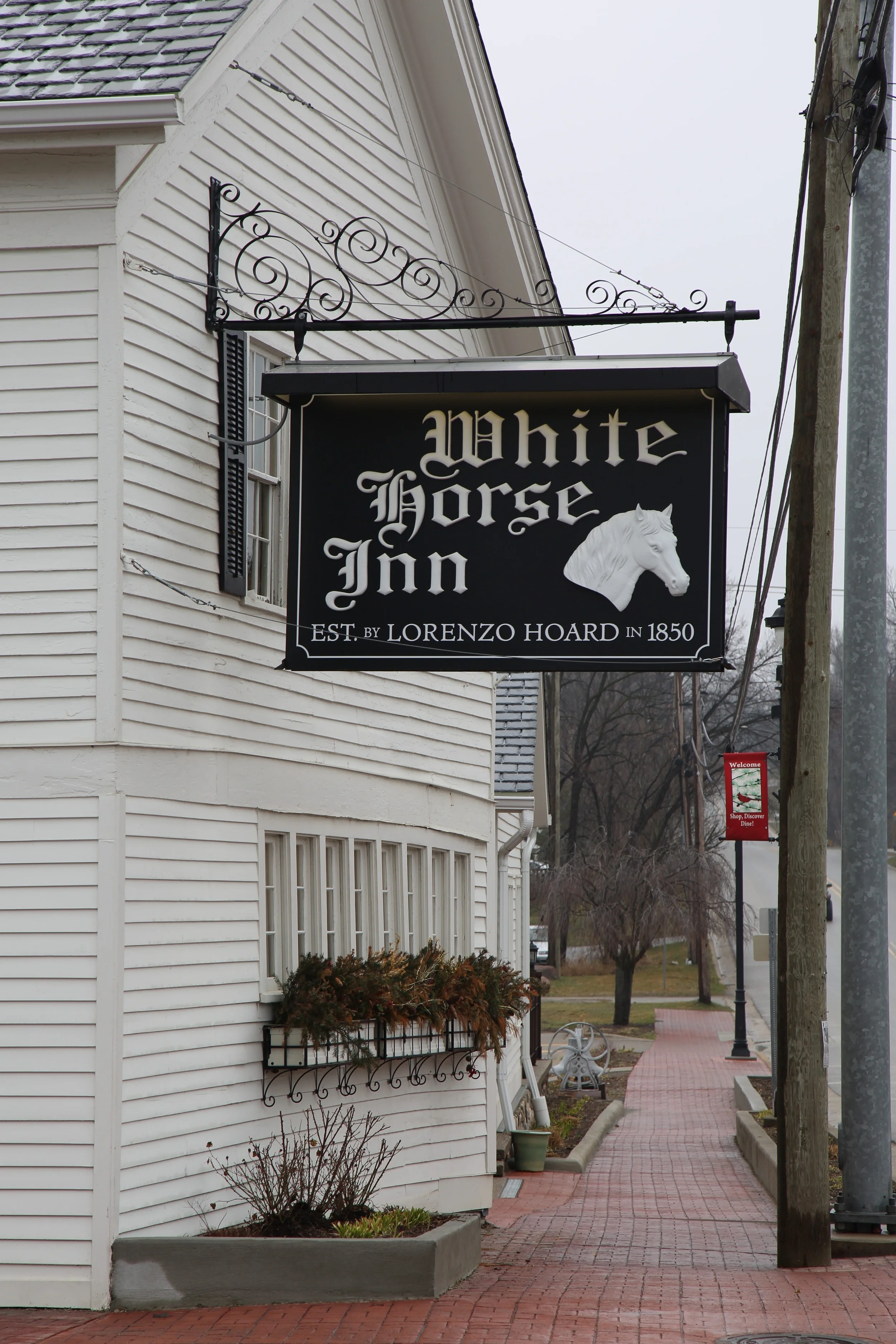 Exterior An iconic visual in Metamora, the White Horse Inn continues to remain a place of pride in the community and beyond. The wrought iron fencing on the patio is from an early 1900s Saline, Michigan cemetery, fitted and installed by Metamora ironworkers Bill Palmer and Robert Warren. The cobblestone skirting is from stones collected at the inn owner's Metamora farm. Do you hear that ringing? It might be the 1875 Metamora Normal School bell, donated by the Boy Scout Camp D-BAR-A.