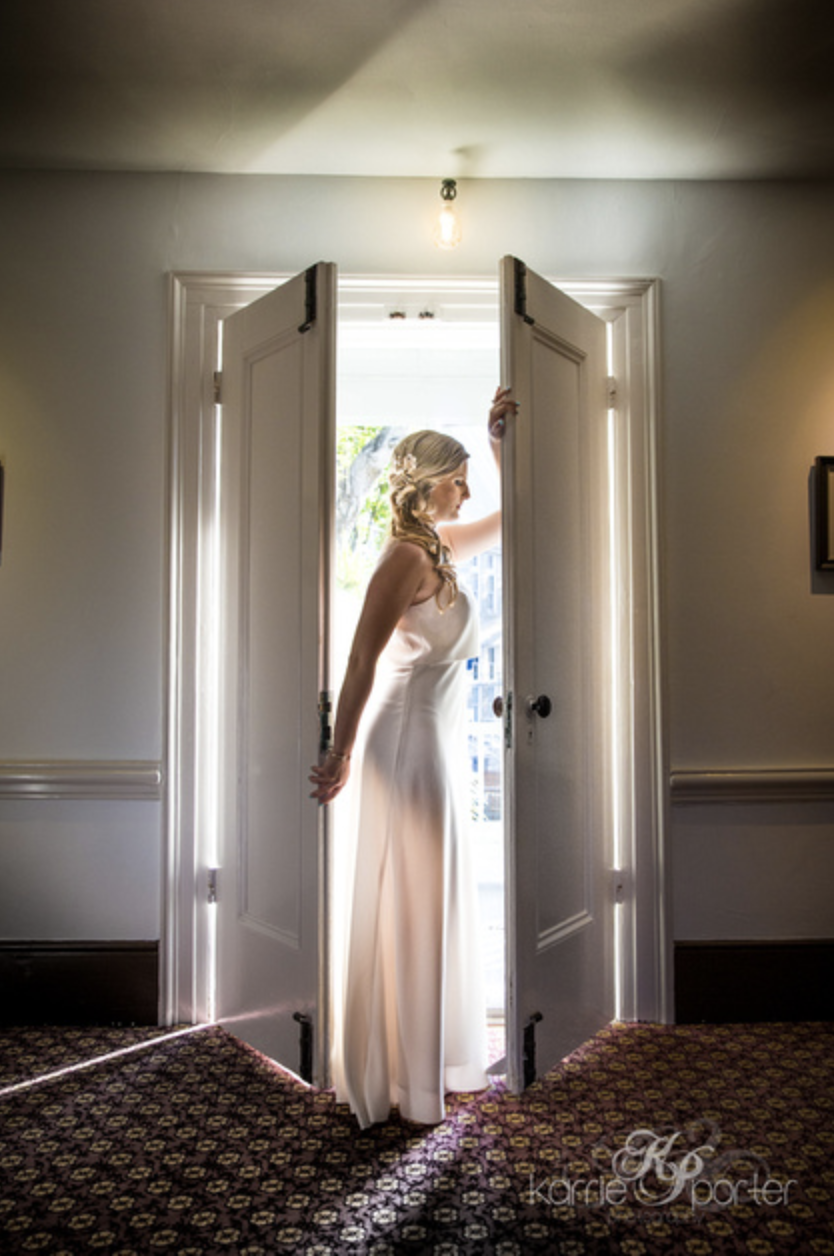 Backlit-Portrait-of-Bride-In-Doorway-Audubon-House.png