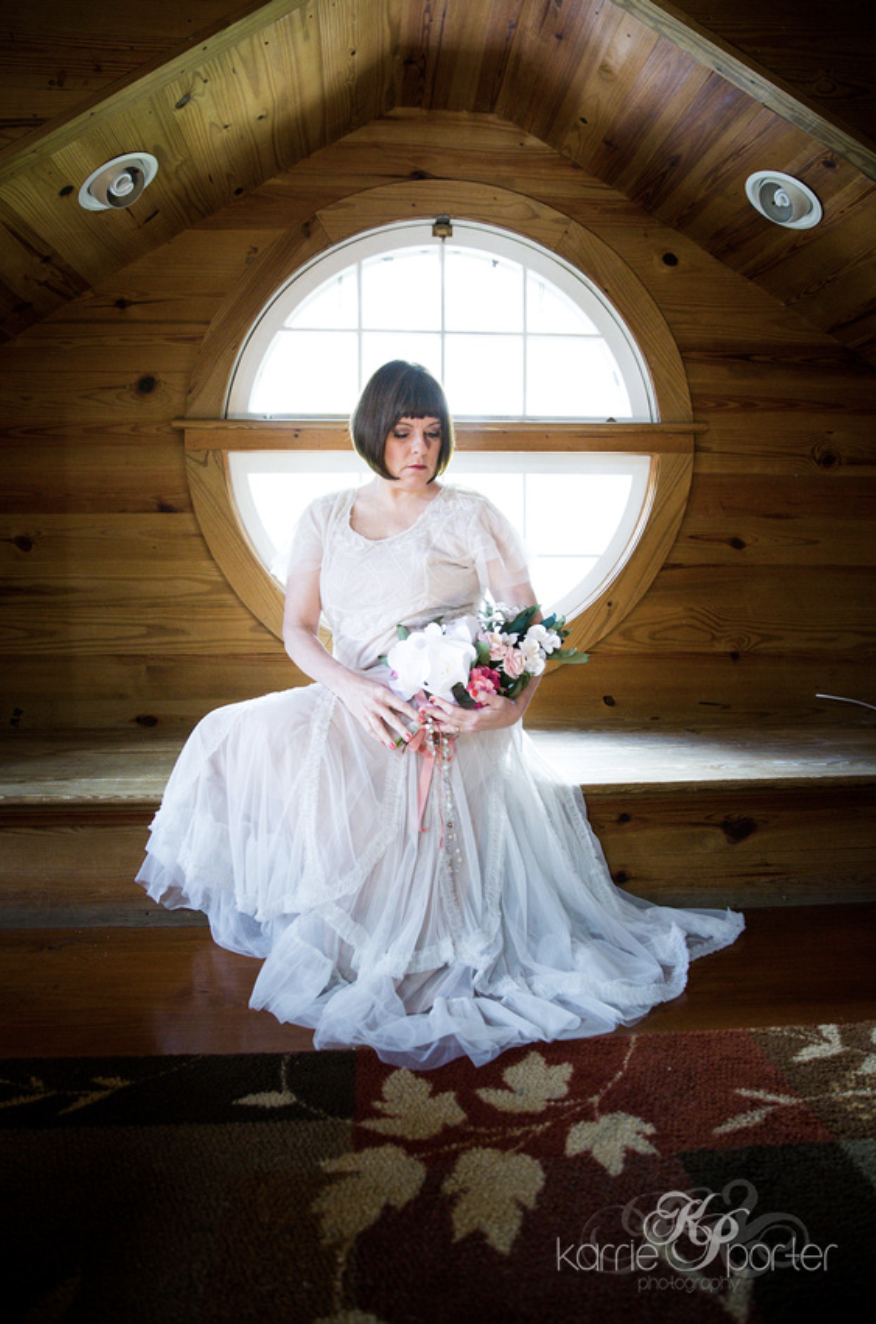 Bride-Holding-Flowers-By-Circular-Window-at-Rose-Lane-Villas-Key-West.png