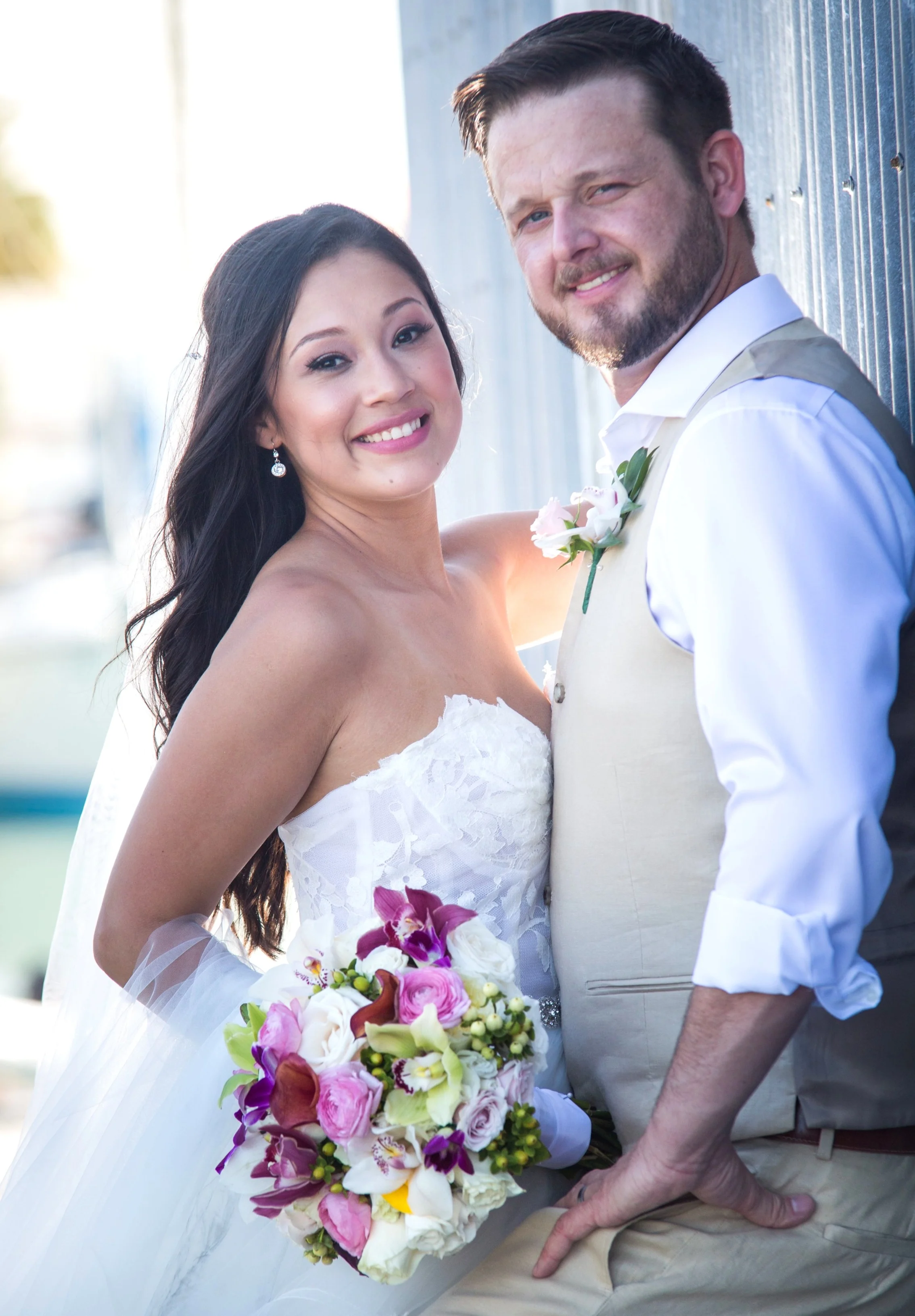 Couple pose next to Turtle History Museum in Key West Bight on wedding day