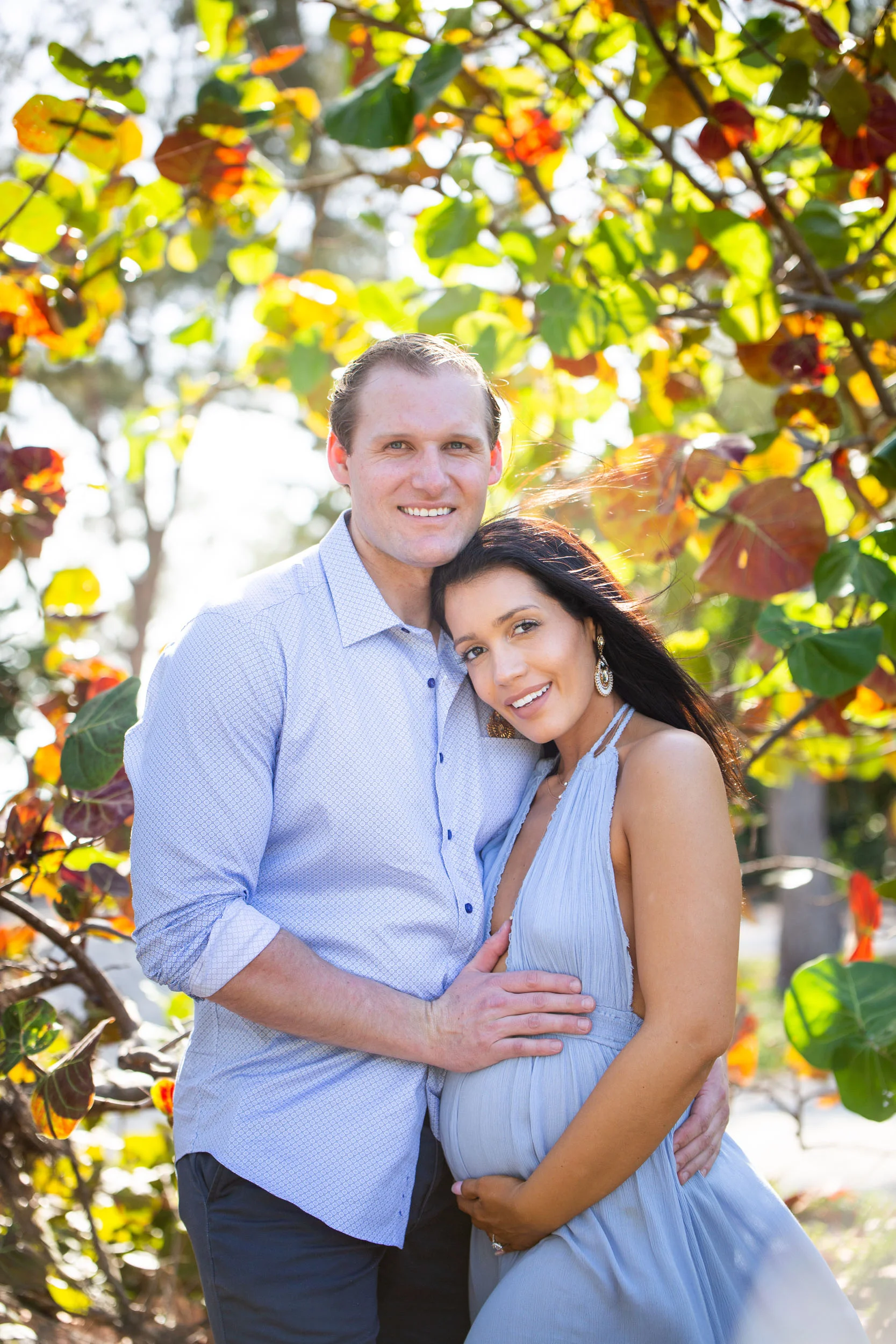 Beautiful maternity shot of couple under sea grape leaves in Key West