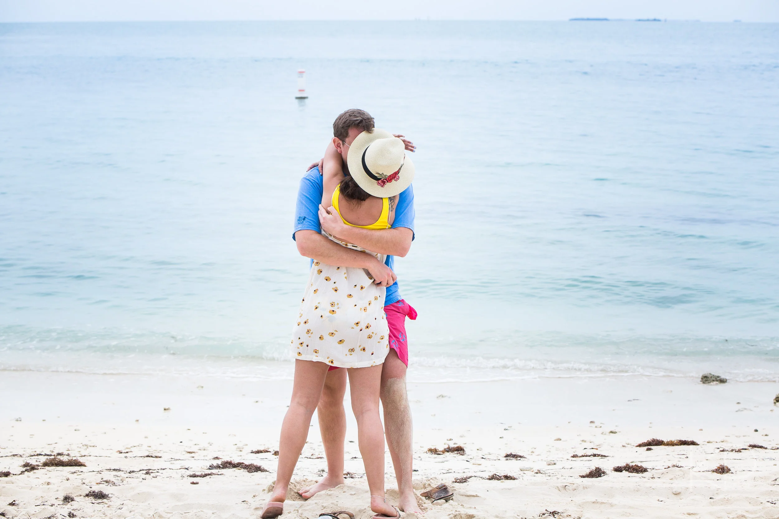 Couple gets engaged during undercover proposal photo shoot on Sunset Key private island at Crescent Beach off the coast of Key West Florida
