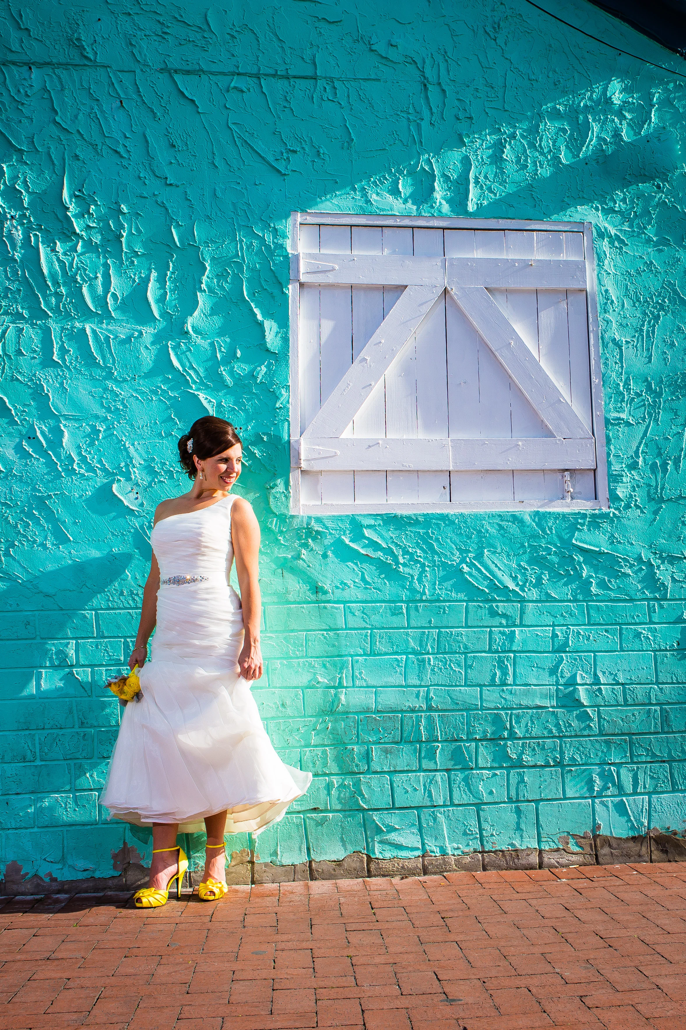 Bride Posing on Teal Blue Wall with Yellow Heels in Bahama Village Key West