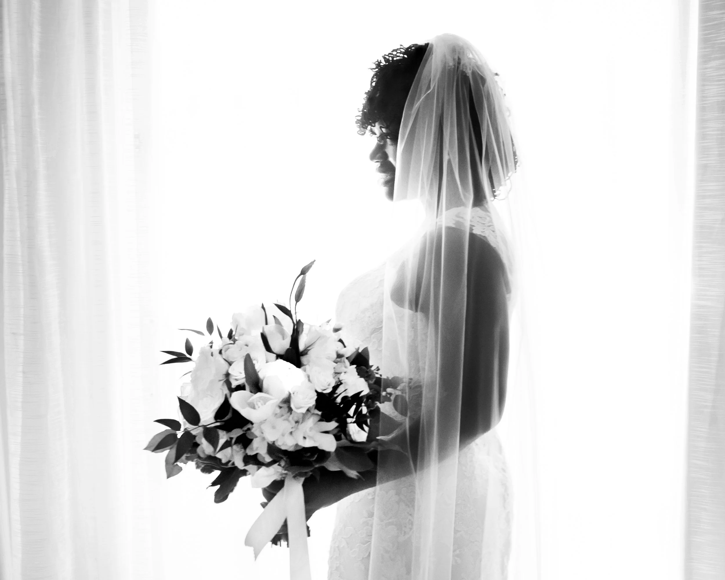 Bride in window with glow behind her.jpg