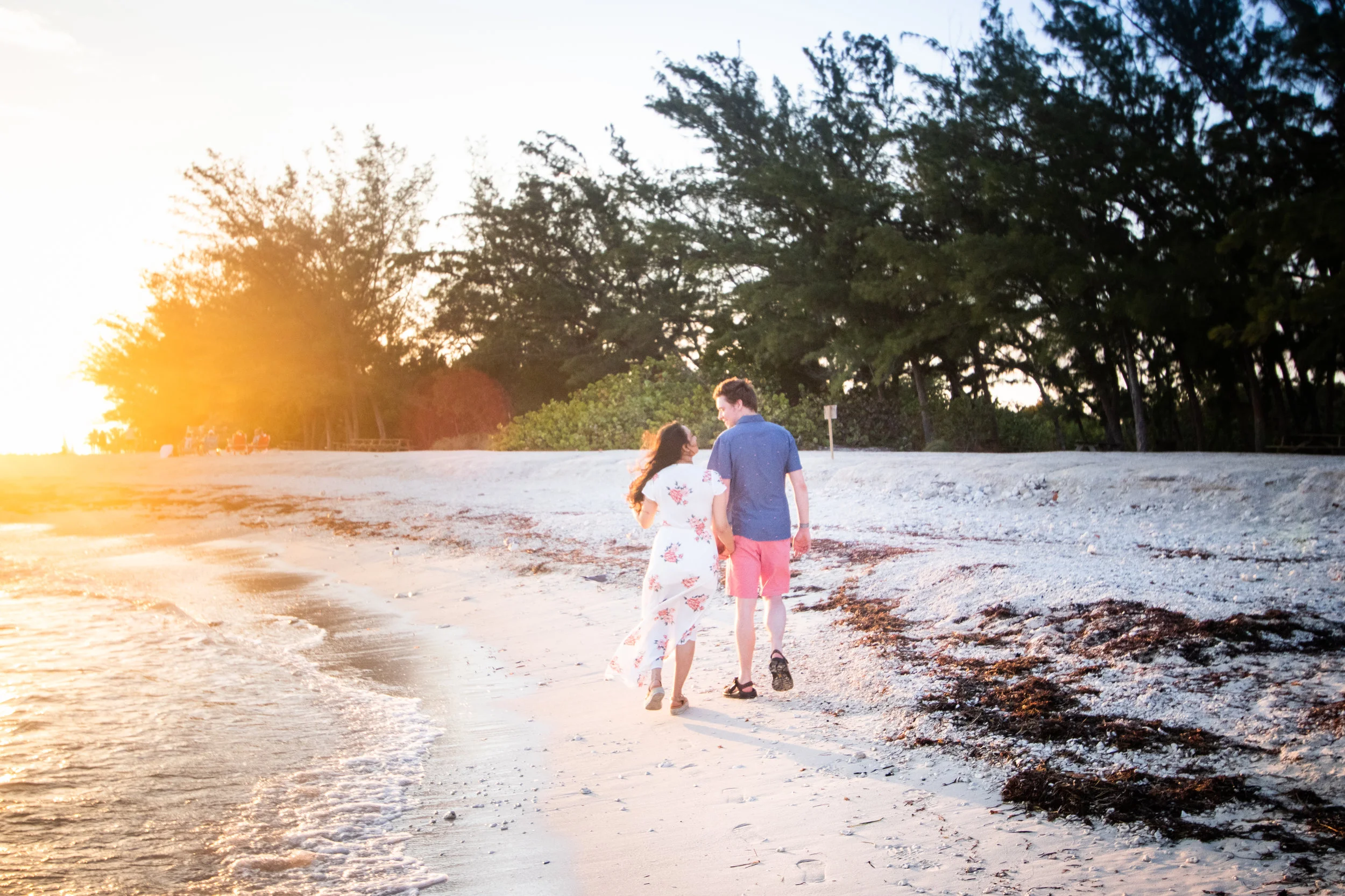 Secret Engagement session with couple walking on beach.jpg