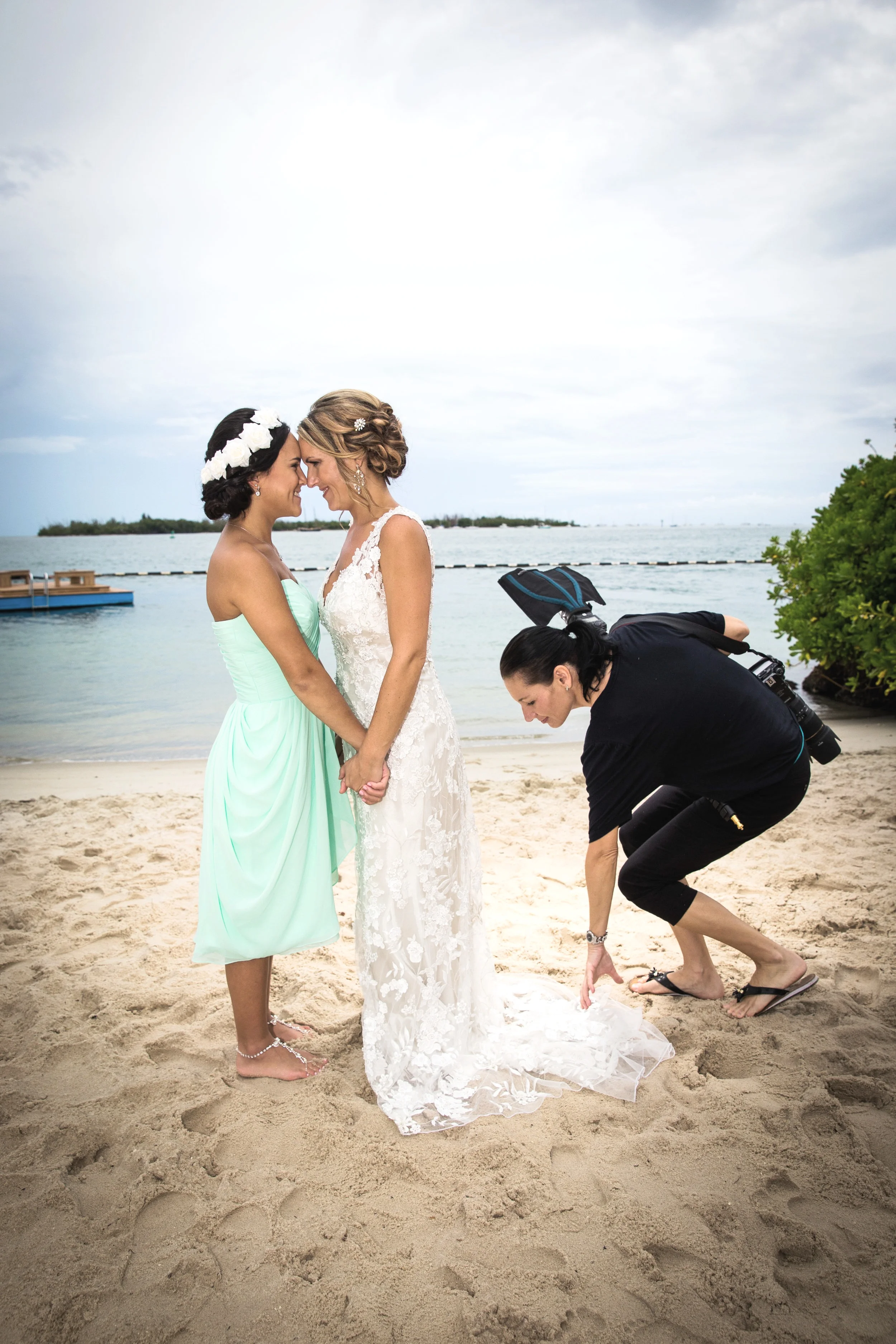 Photography Assistant Spreading out the train of the dress on a Key West wedding day.jpg