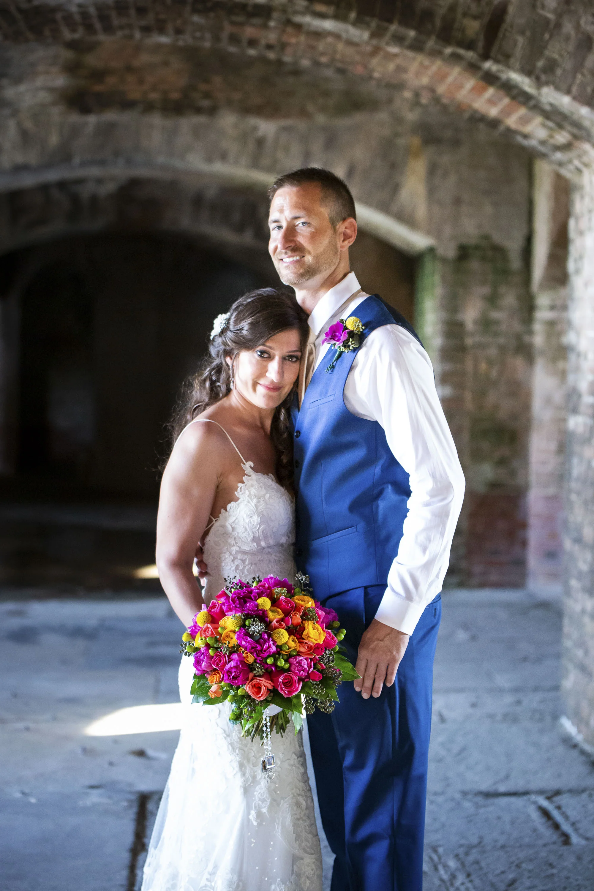 Couple getting married under fortress arches