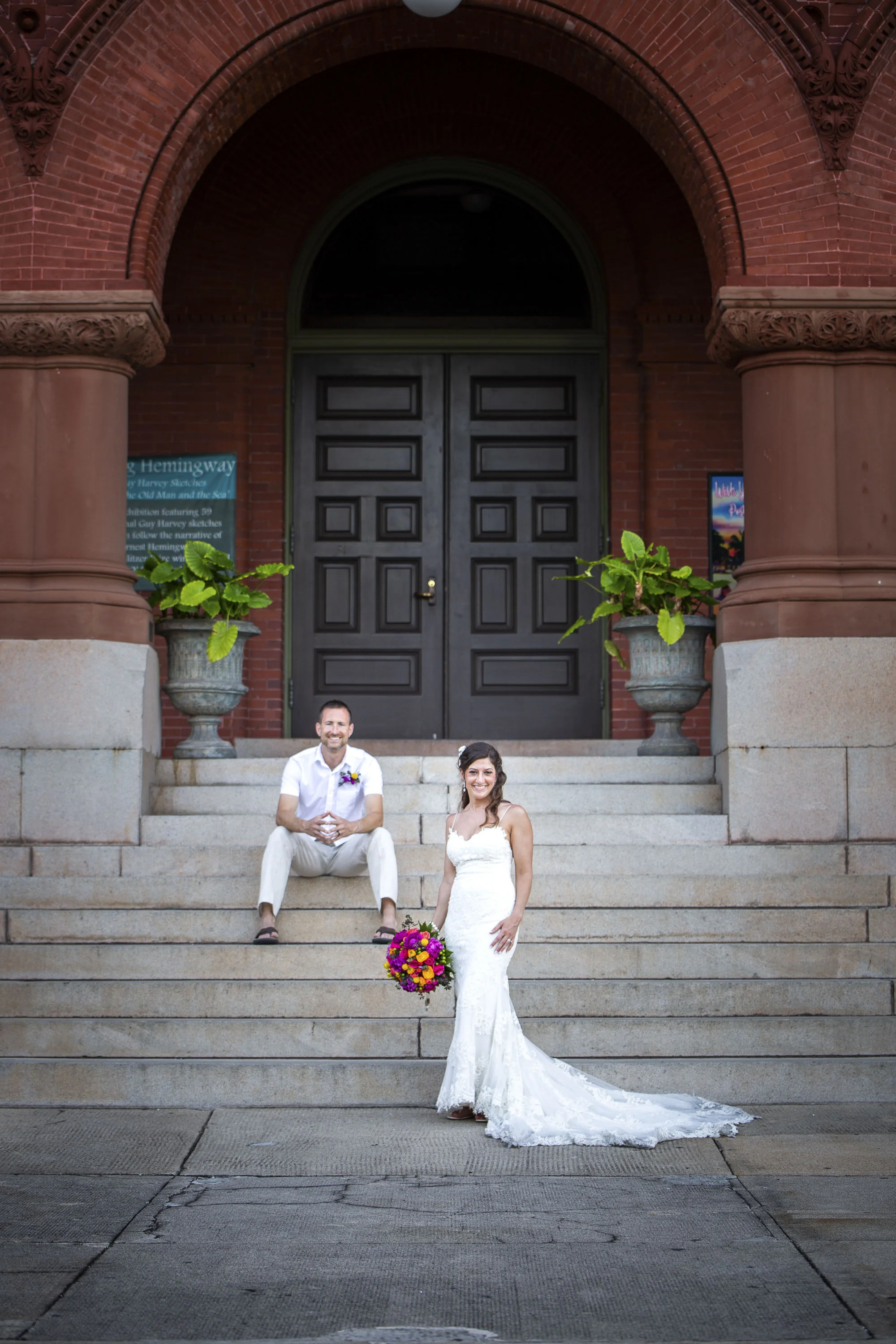 Bride and groom posing on the steps of the Key West customs house