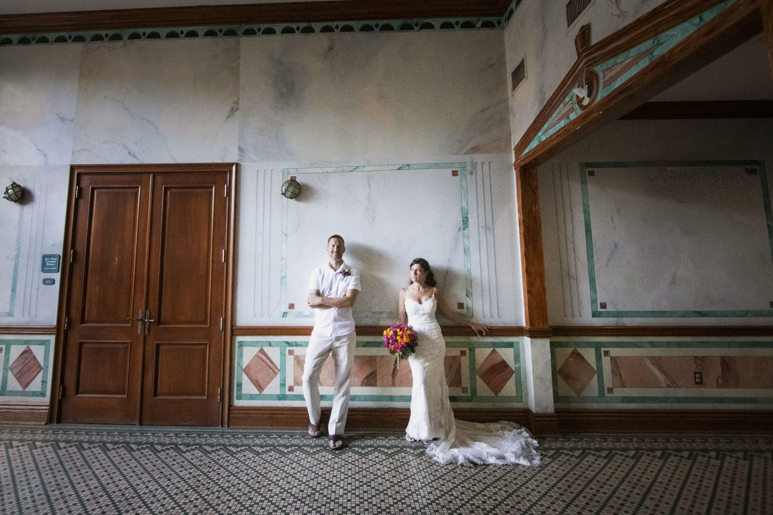 Bride and groom posing in historic building in Key West