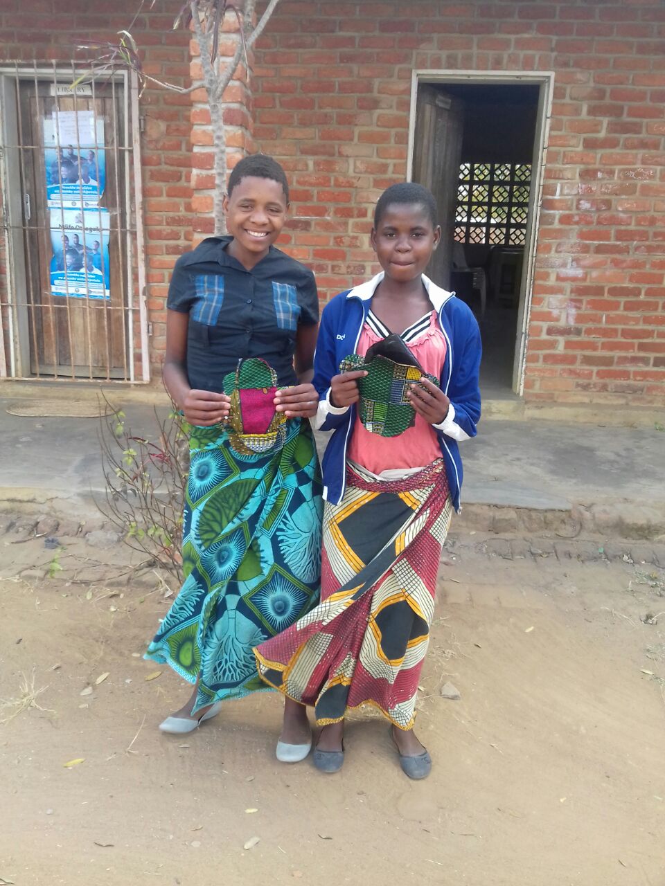 Two participants proudly show their reusable pads.