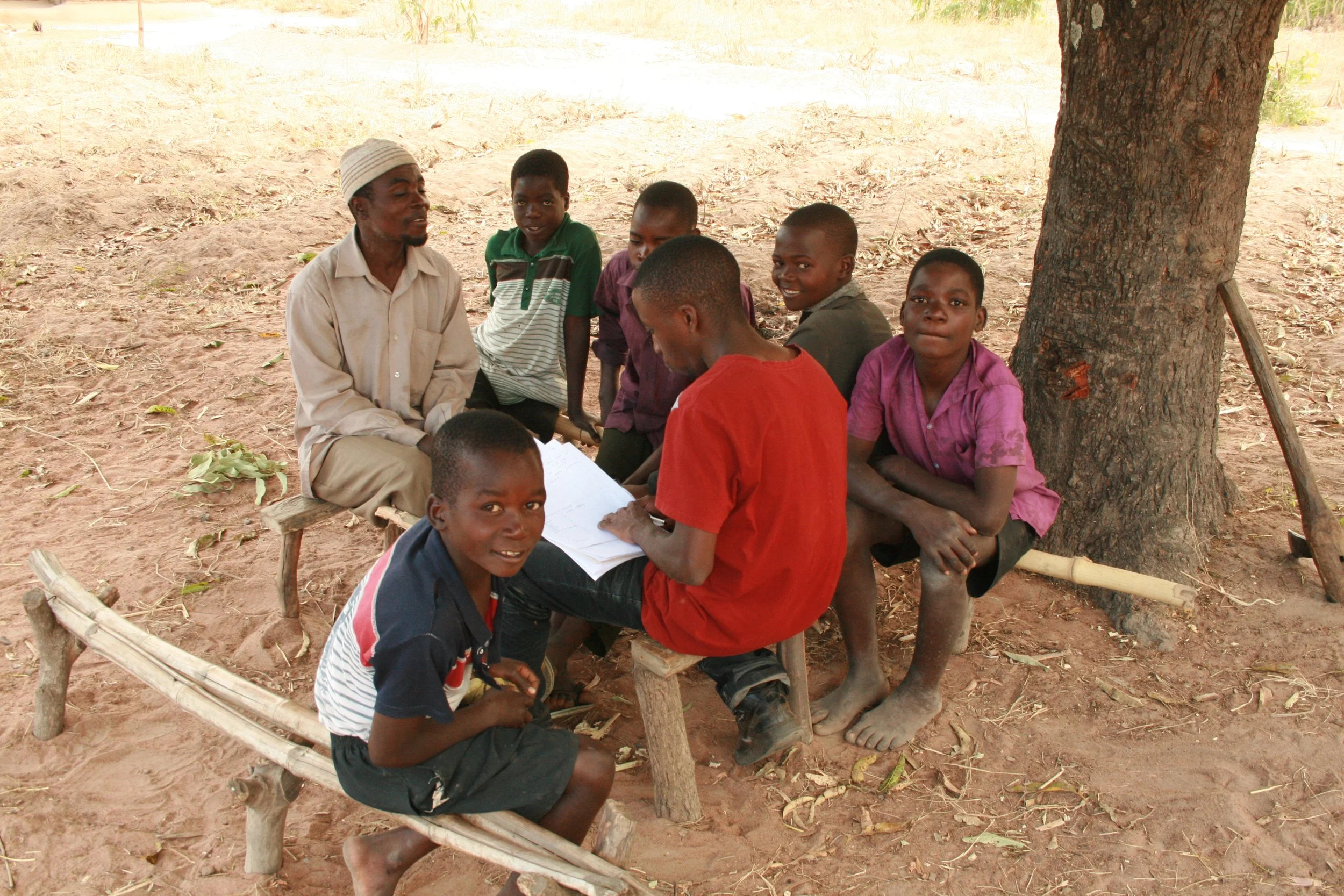 James' family member being interviewed by a Story Time volunteer, surrounded by neighbors.