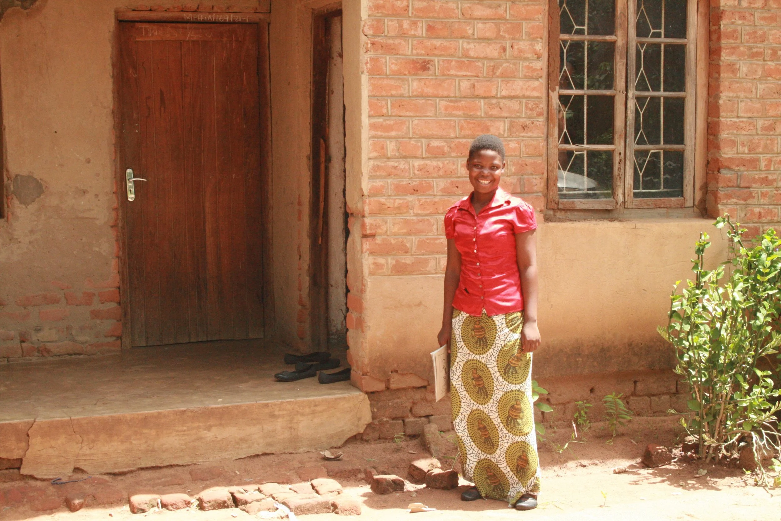 Chikondi, during her Form 2, standing near her dormitory less than 1 kilometer from the school.