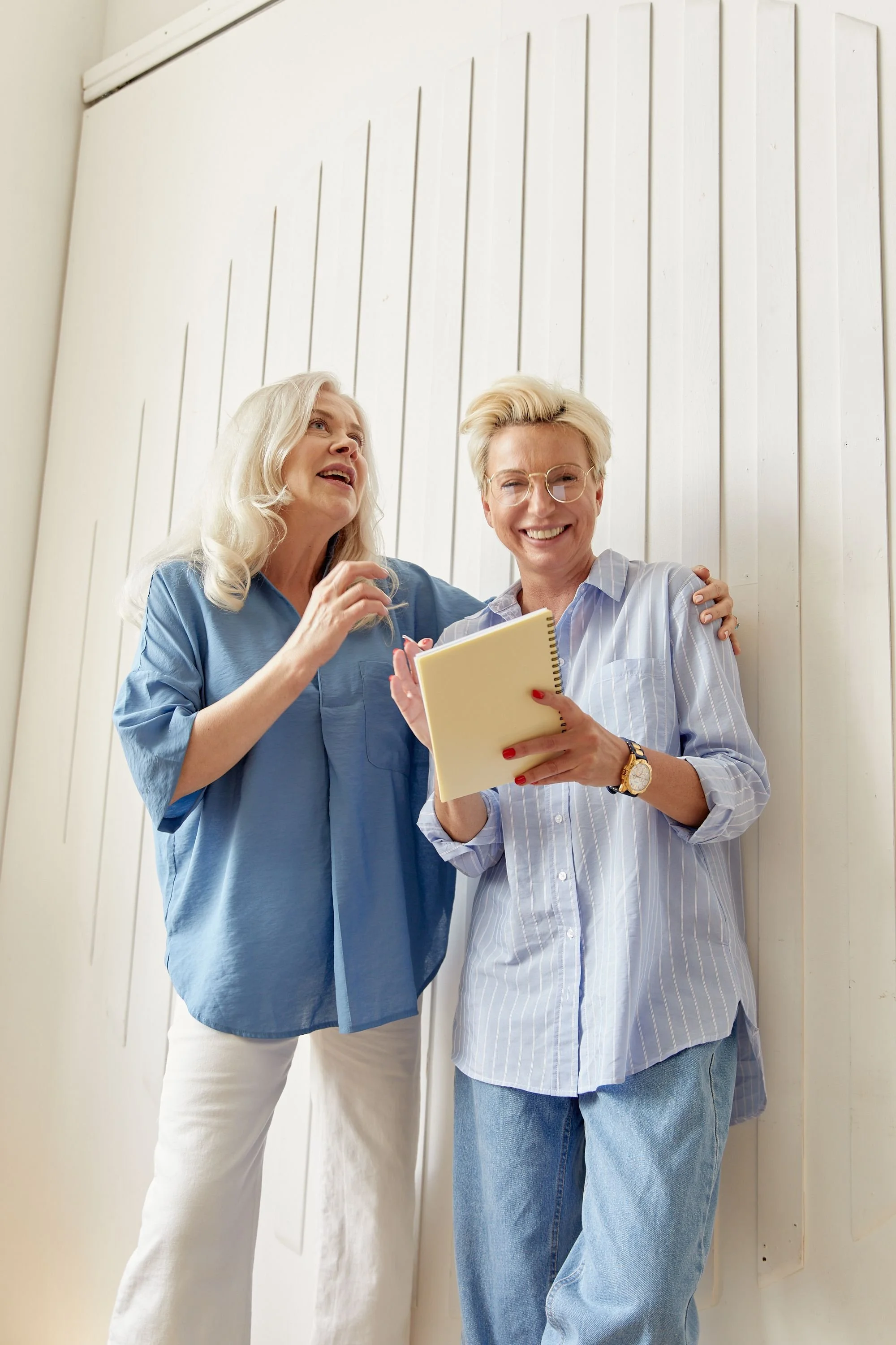 two women happily talking about pregnancy stress