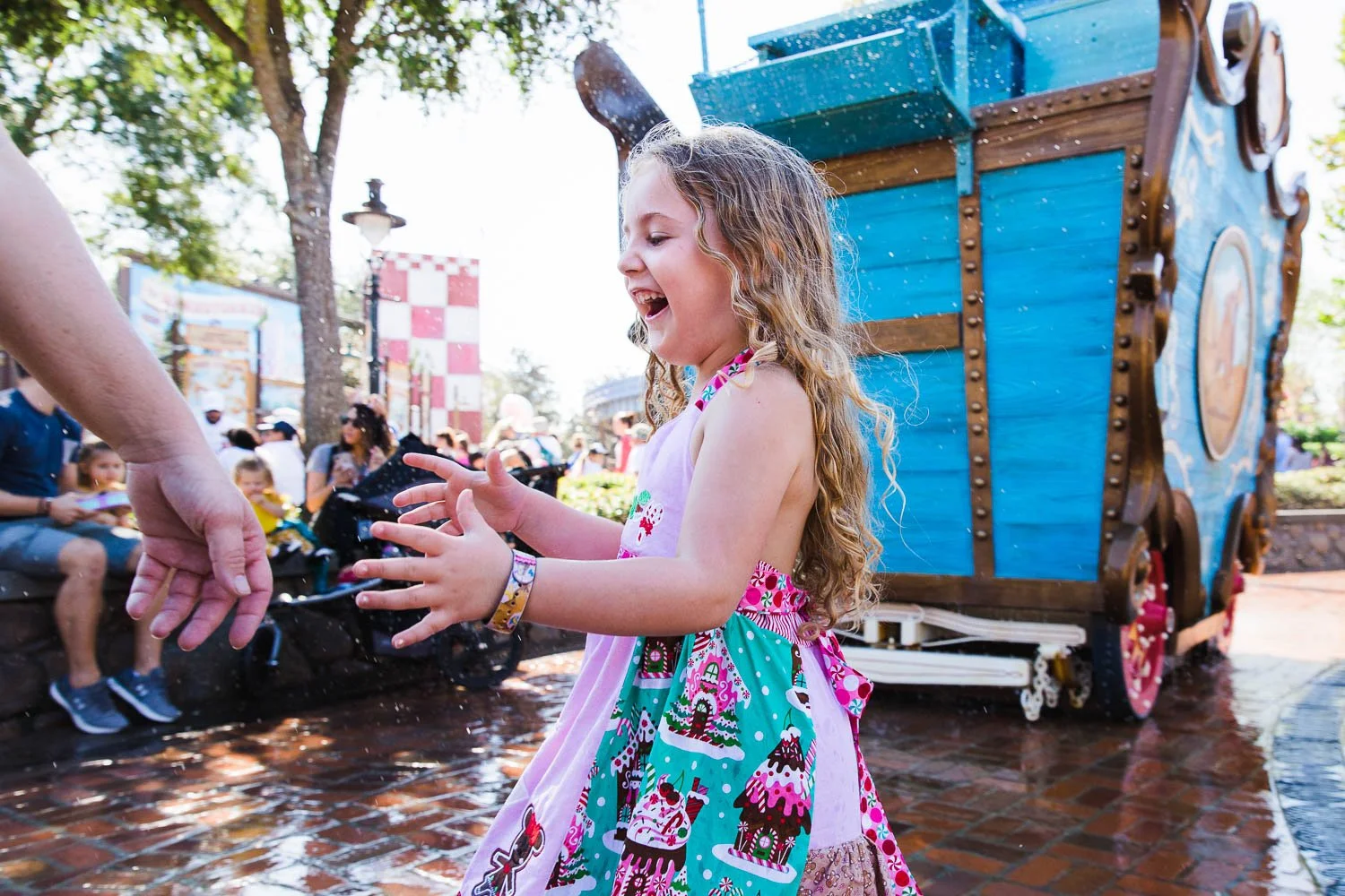 Child runs through Casey Jr. water feature at Magic Kingdom.