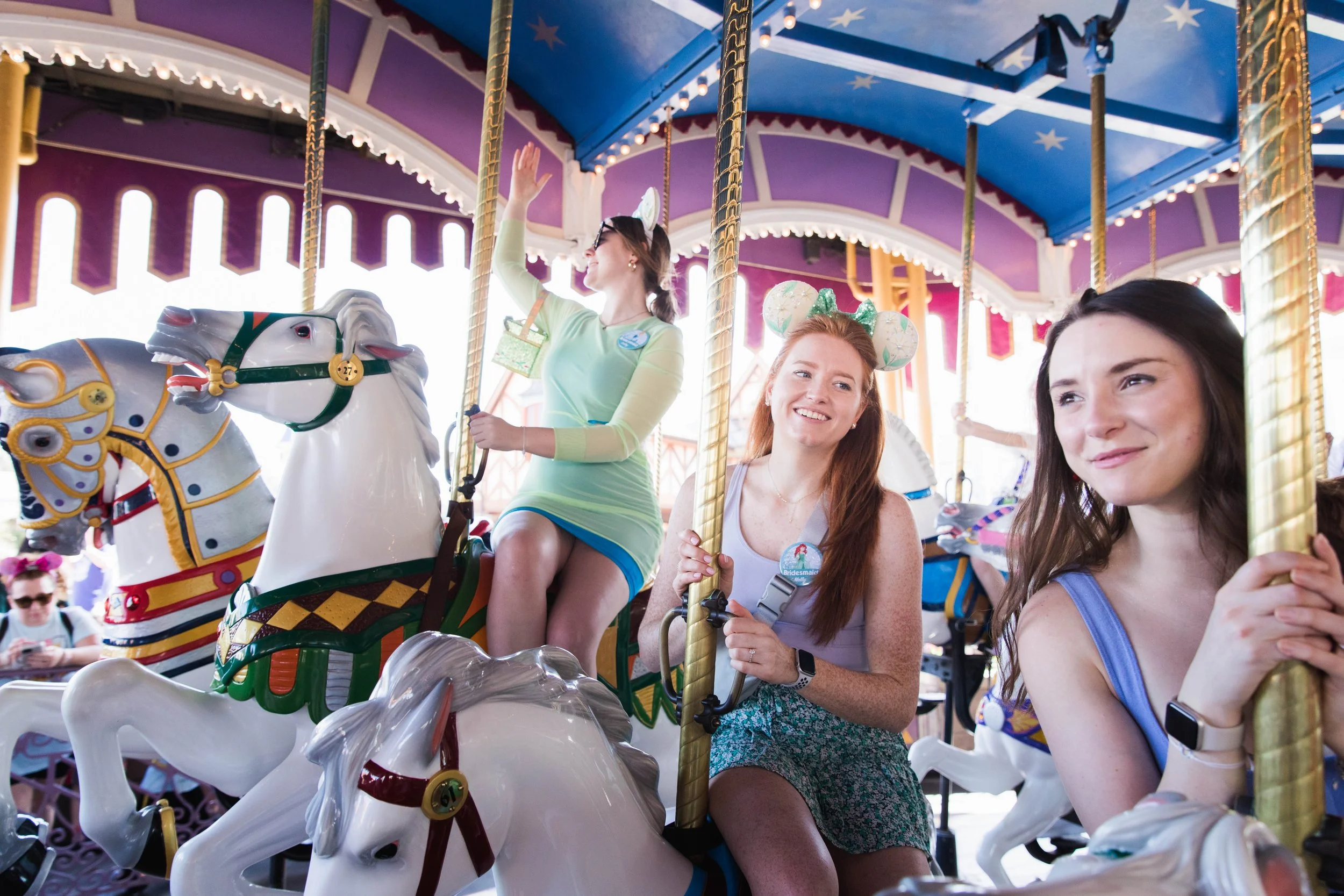 Young women ride Prince Charming Regal Carrousel at Magic Kingdom.