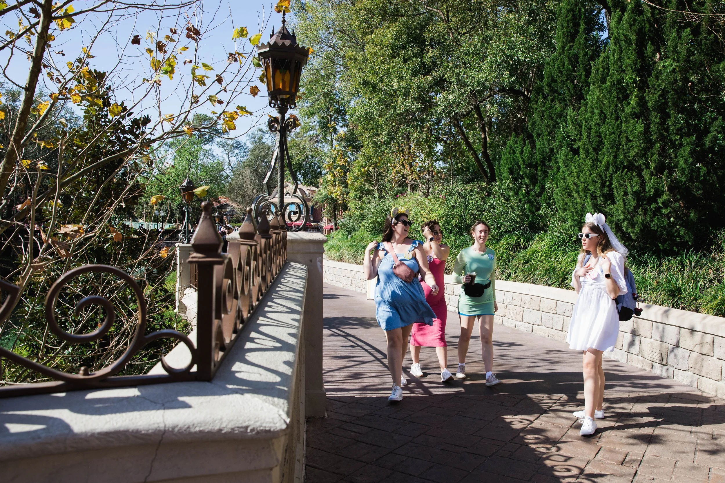 Young women walk by Cinderella Castle on a girls trip to Magic Kingdom.