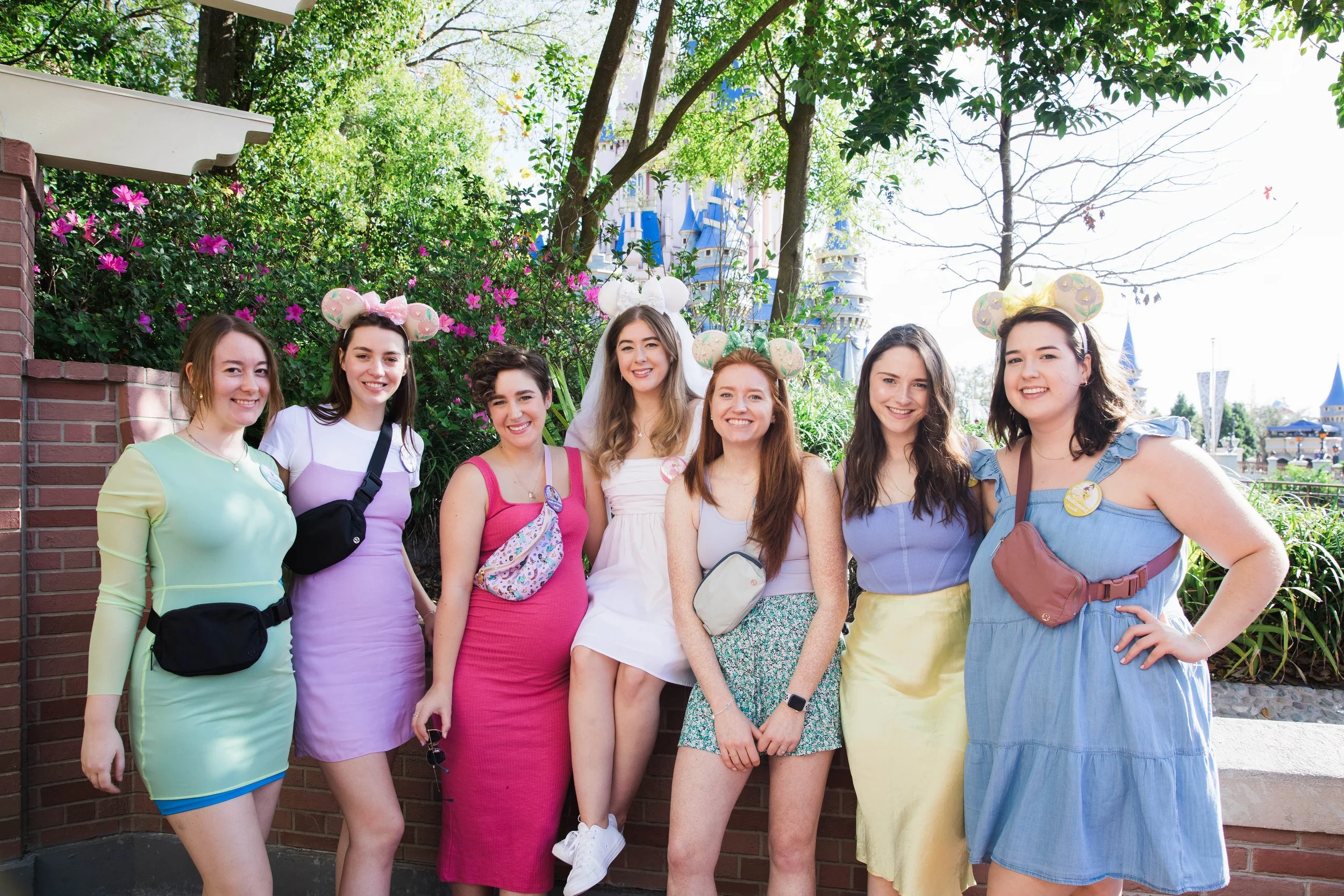 Bachelorette party poses in front of Cinderella Castle.