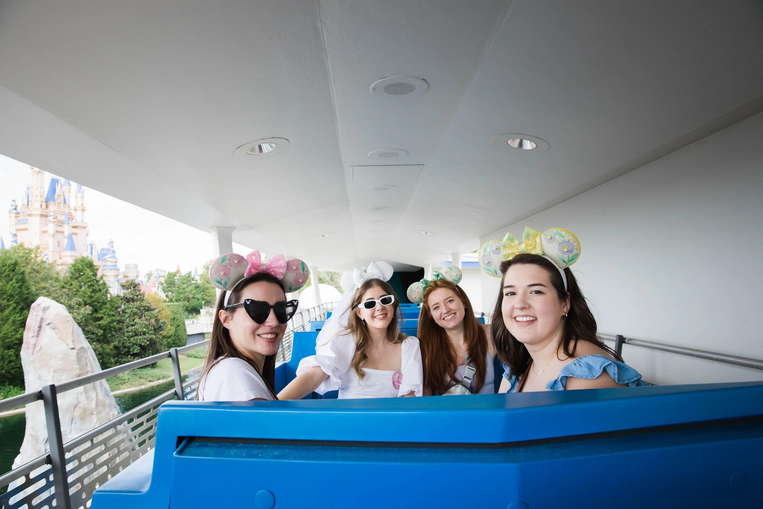Women pose on Tomorrowland Transit Authority Peoplemover on a girls trip to Magic Kingdom.