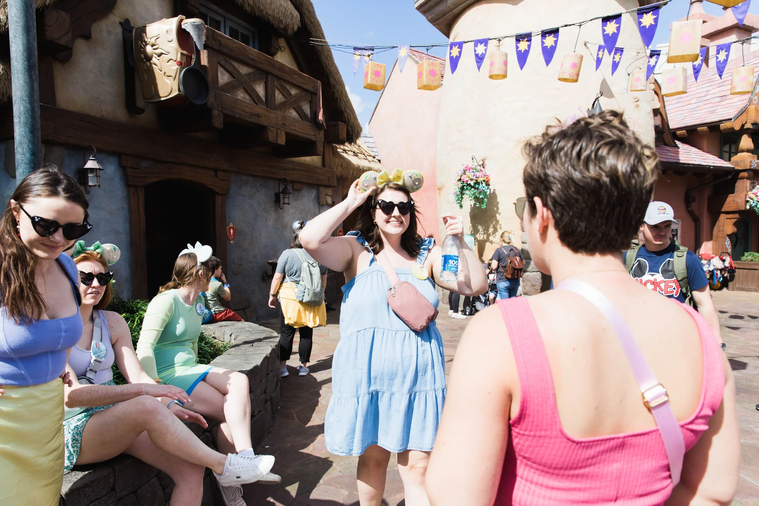 Young women take a break outside the Tangled restrooms in Fantasyland.