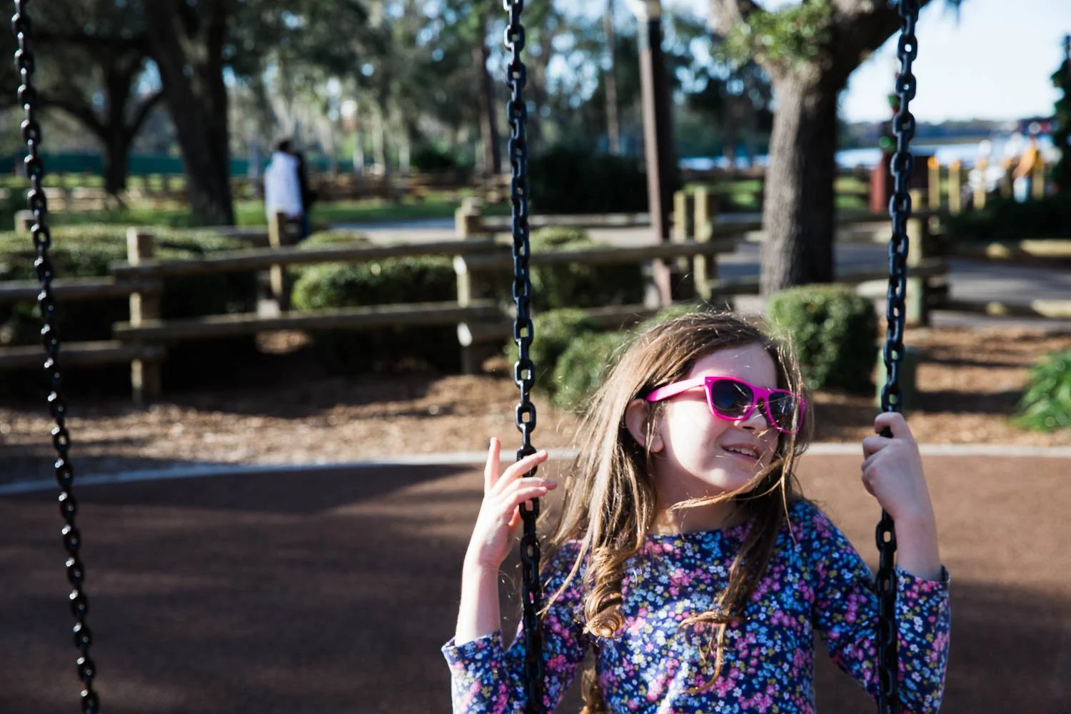 Little girl swings at the playground at Fort Wilderness Resort in Florida.