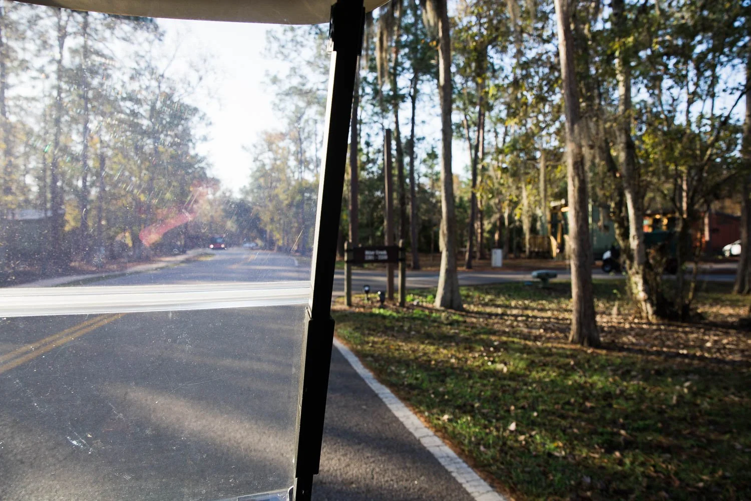 Golf cart views of the trees and campgrounds at Fort Wilderness Resort.