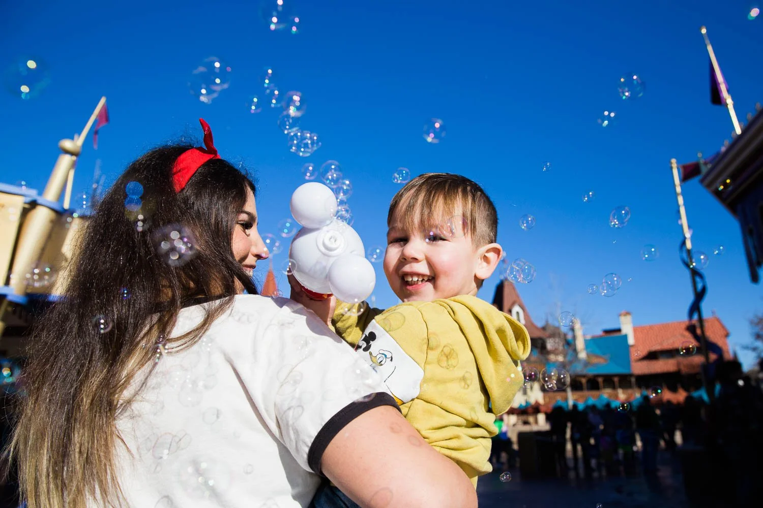 Little boy uses bubble wand at Walt Disney World.