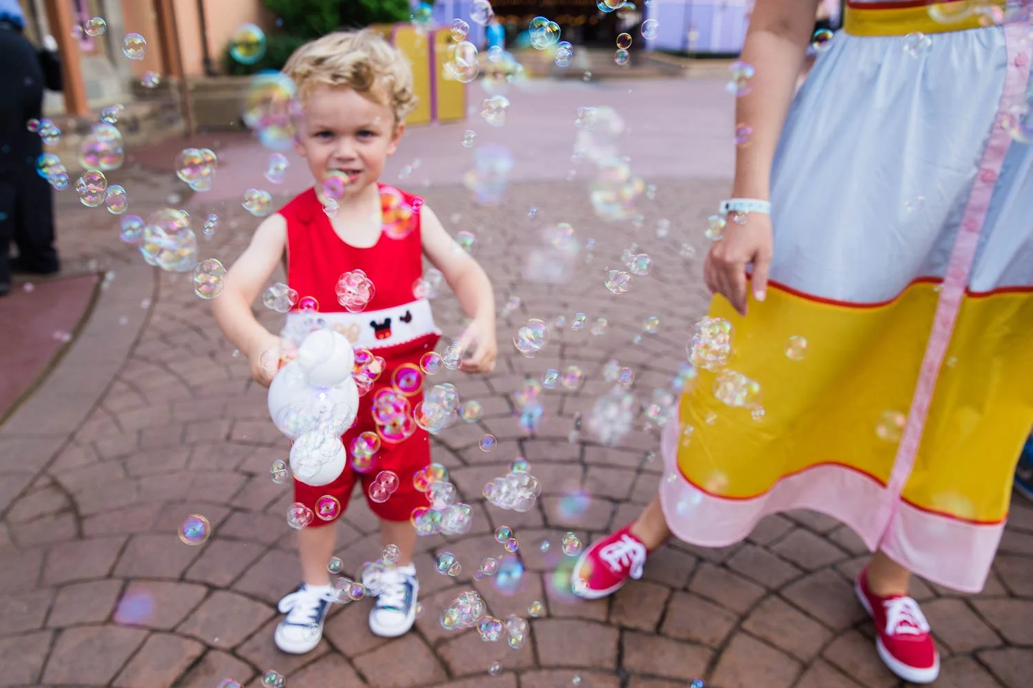 Toddler plays with bubbles at the Magic Kingdom.