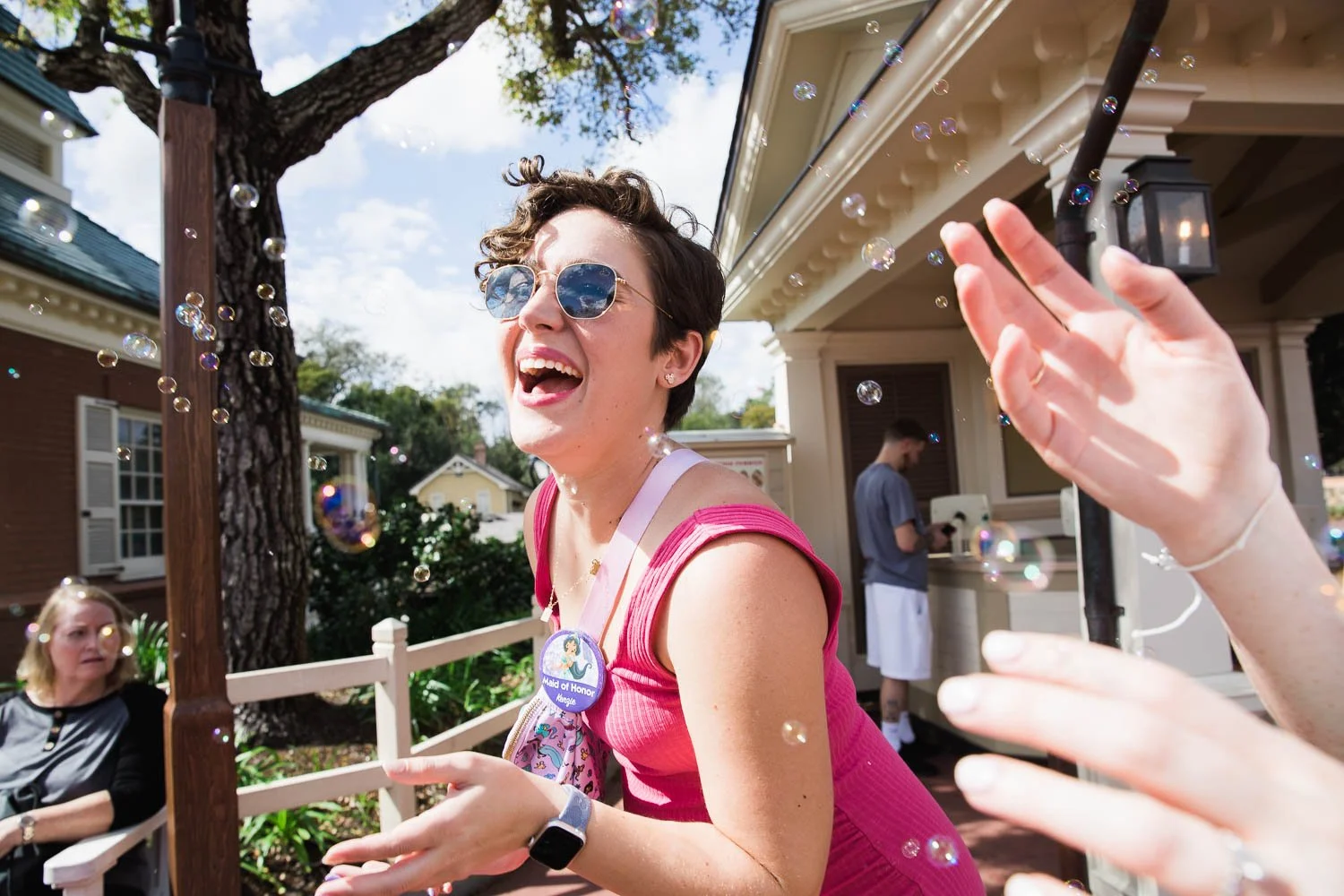 Woman walks through a flurry of bubbles at the Magic Kingdom.