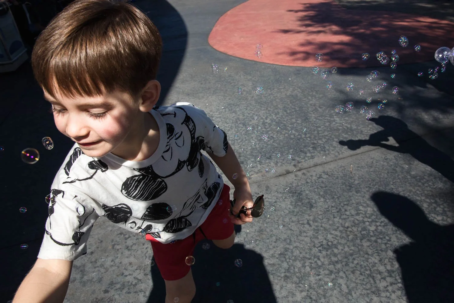 Boy chases bubbles in Tomorrowland at the Magic Kingdom.