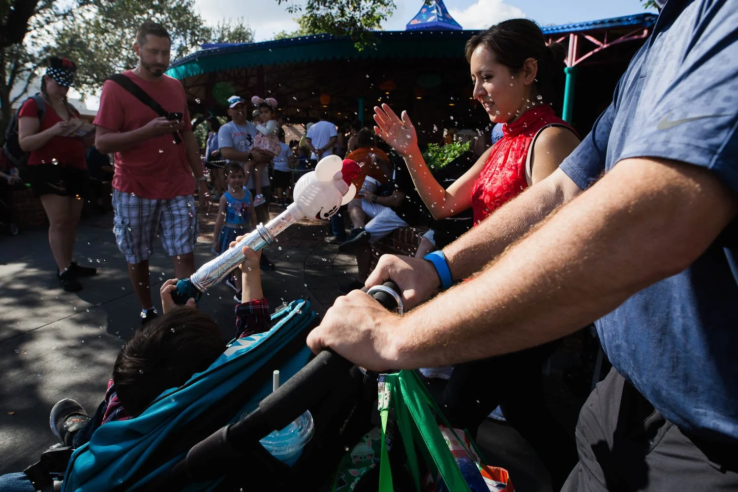 Little boy blows bubbles at his mom at Walt Disney World.