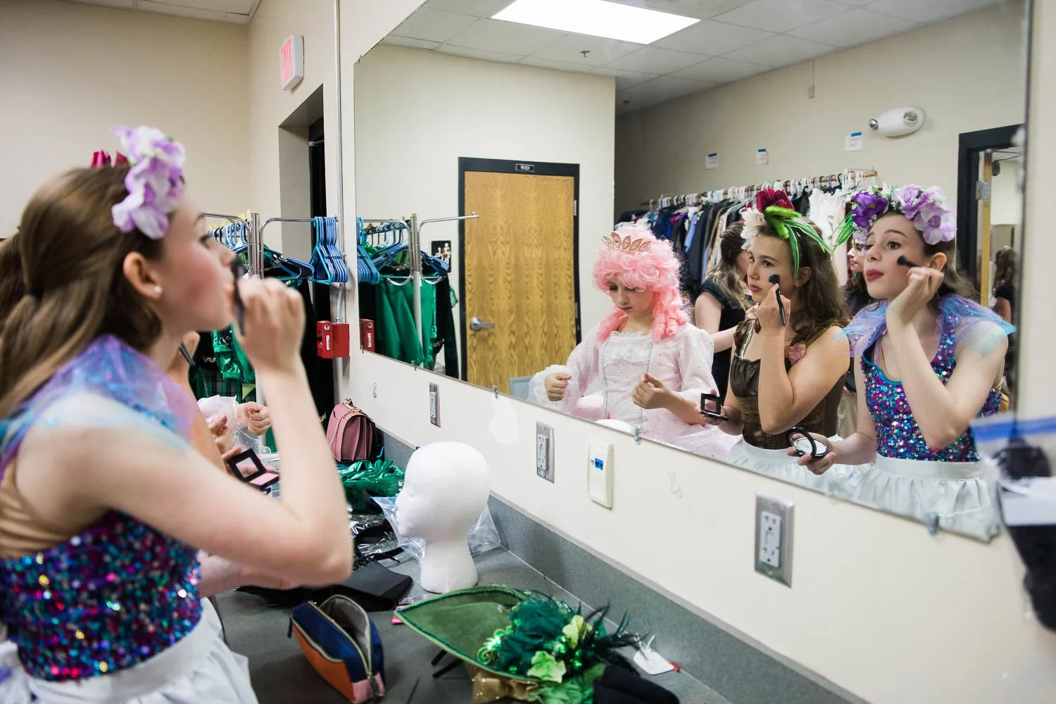 Girls put on makeup in preparation for the Wizard of Oz.