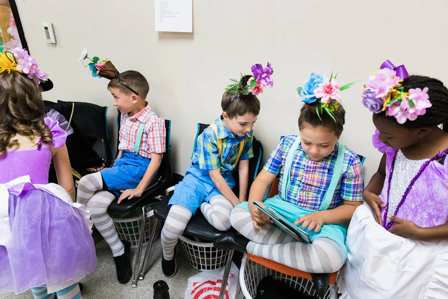 Munchkins wait backstage for the Wizard of Oz.