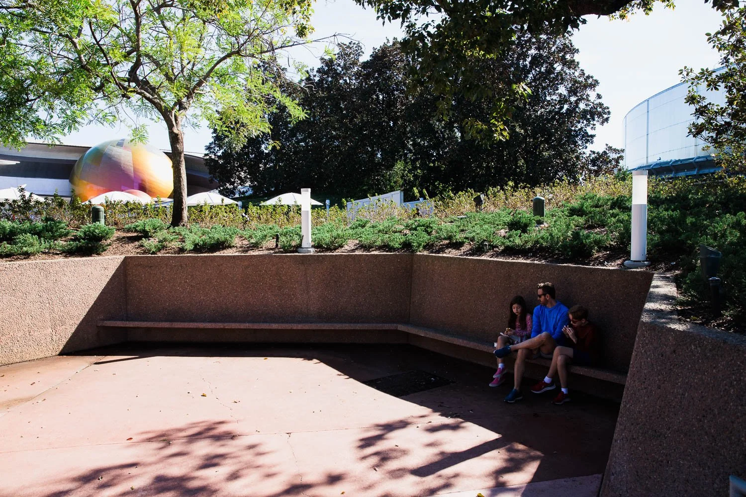 Father and kids take a break in Future World at Epcot.
