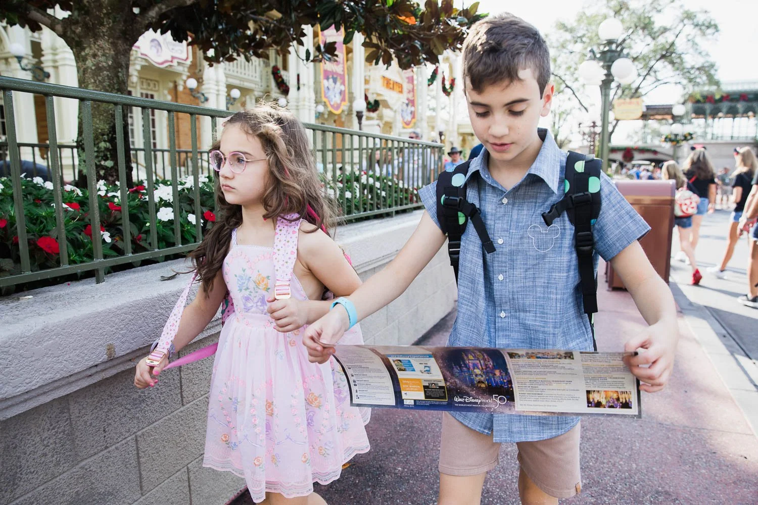 Kids use a map to navigate Main Street USA at Walt Disney World.