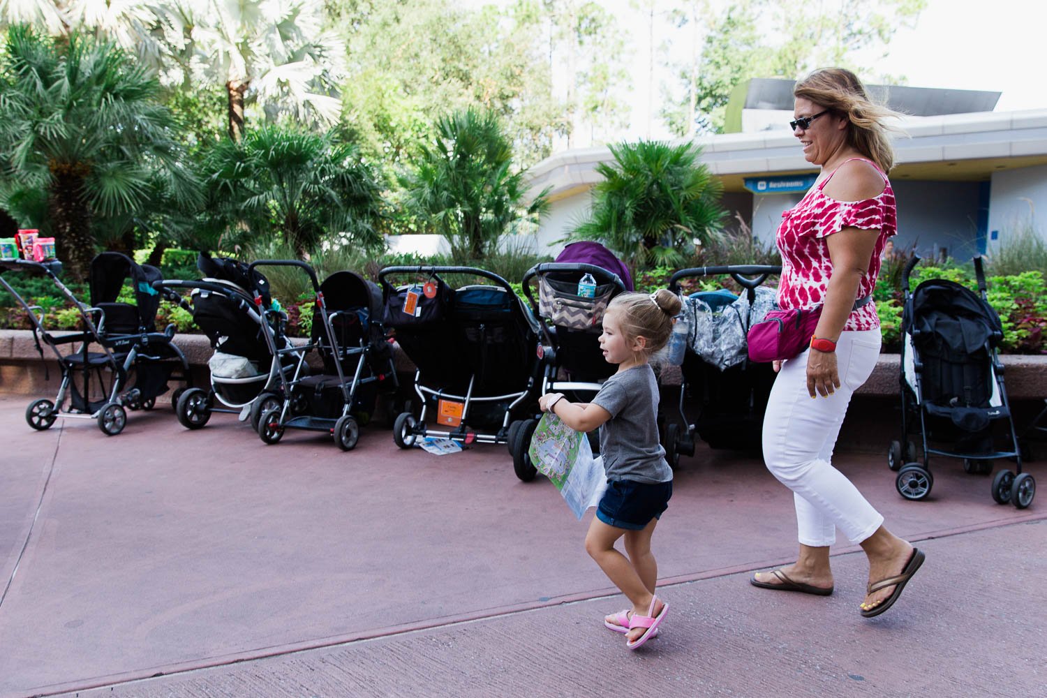 Toddler leads grandmother through Epcot using a guide map.