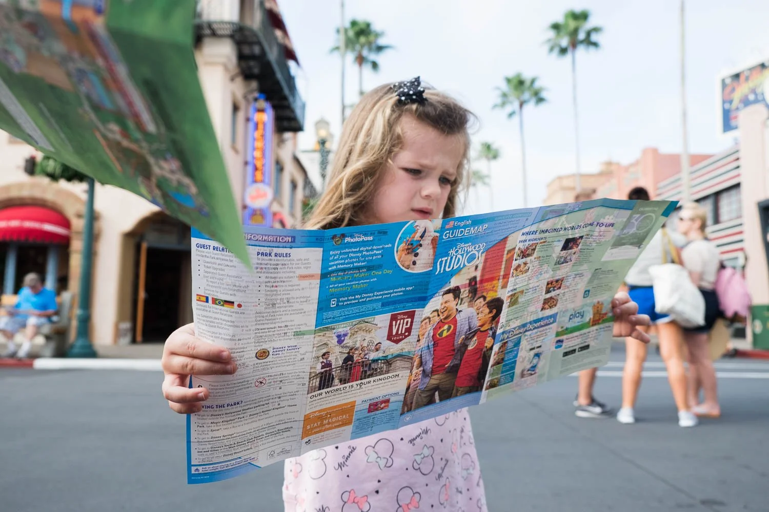 Toddler looks at Disney park map at Hollywood Studios.