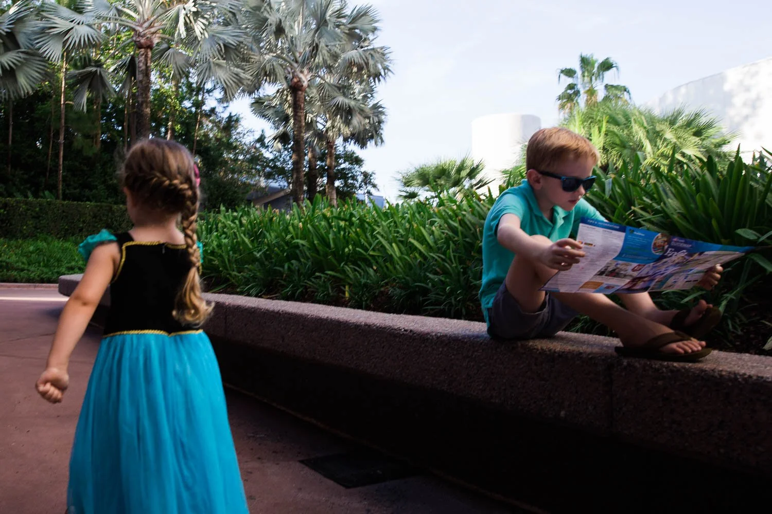 Boy checks out an Epcot map near Spaceship Earth.