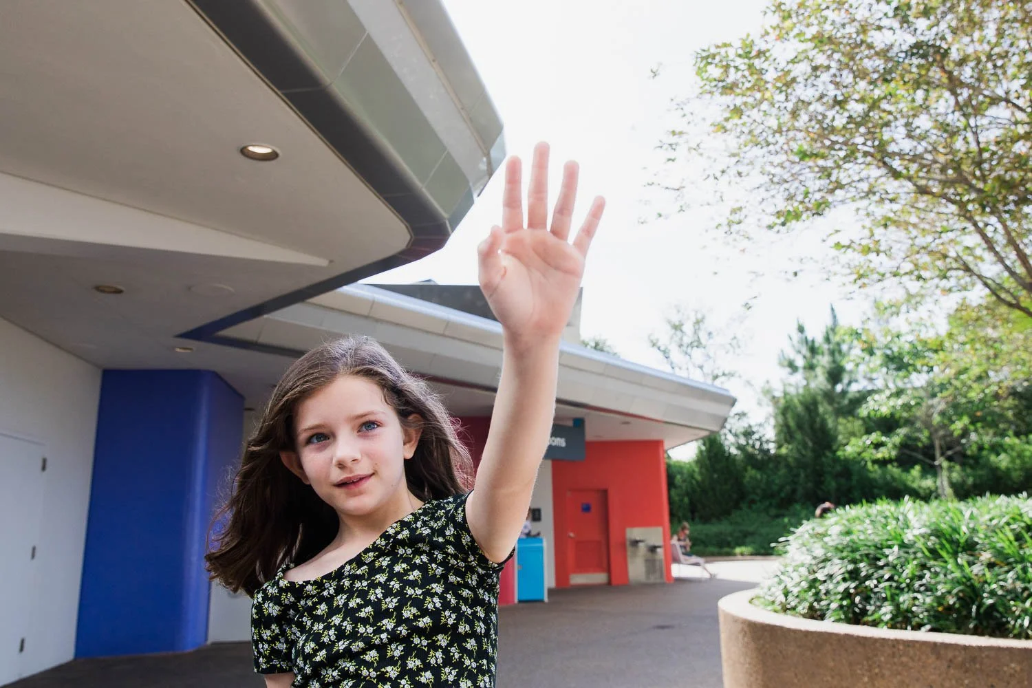 Girl looks towards Spaceship Earth at Epcot.