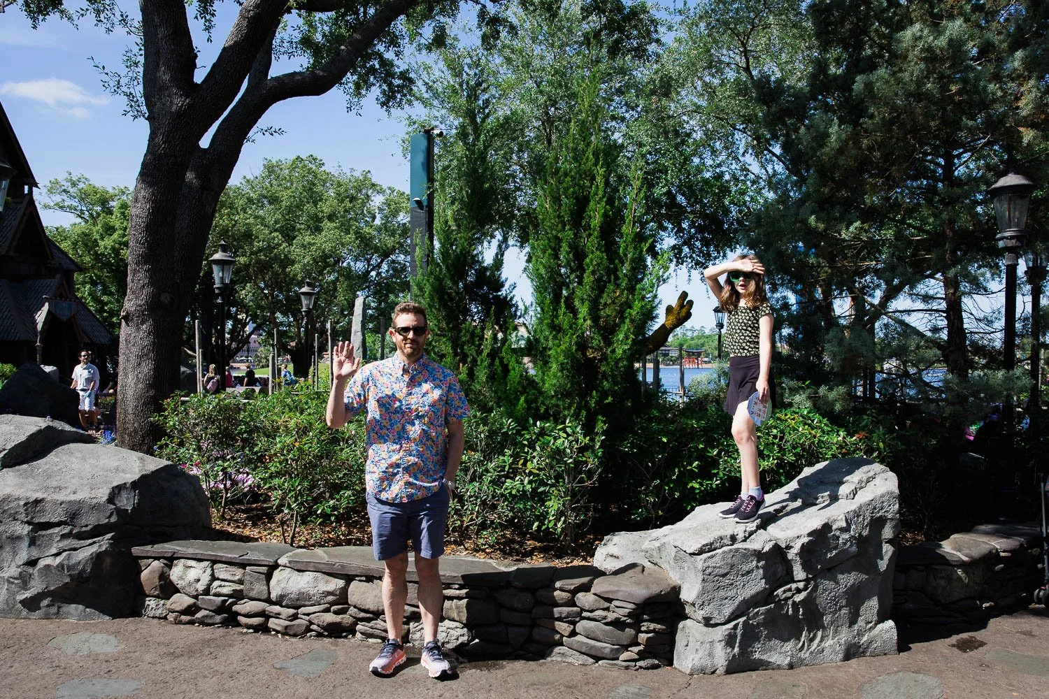 Father and daughter wave in Norway pavilion at Epcot.