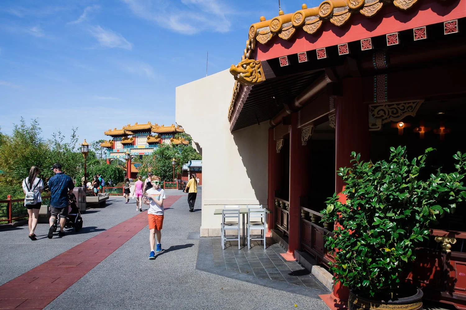Pre teen walks through China Pavilion at Epcot World Showcase.