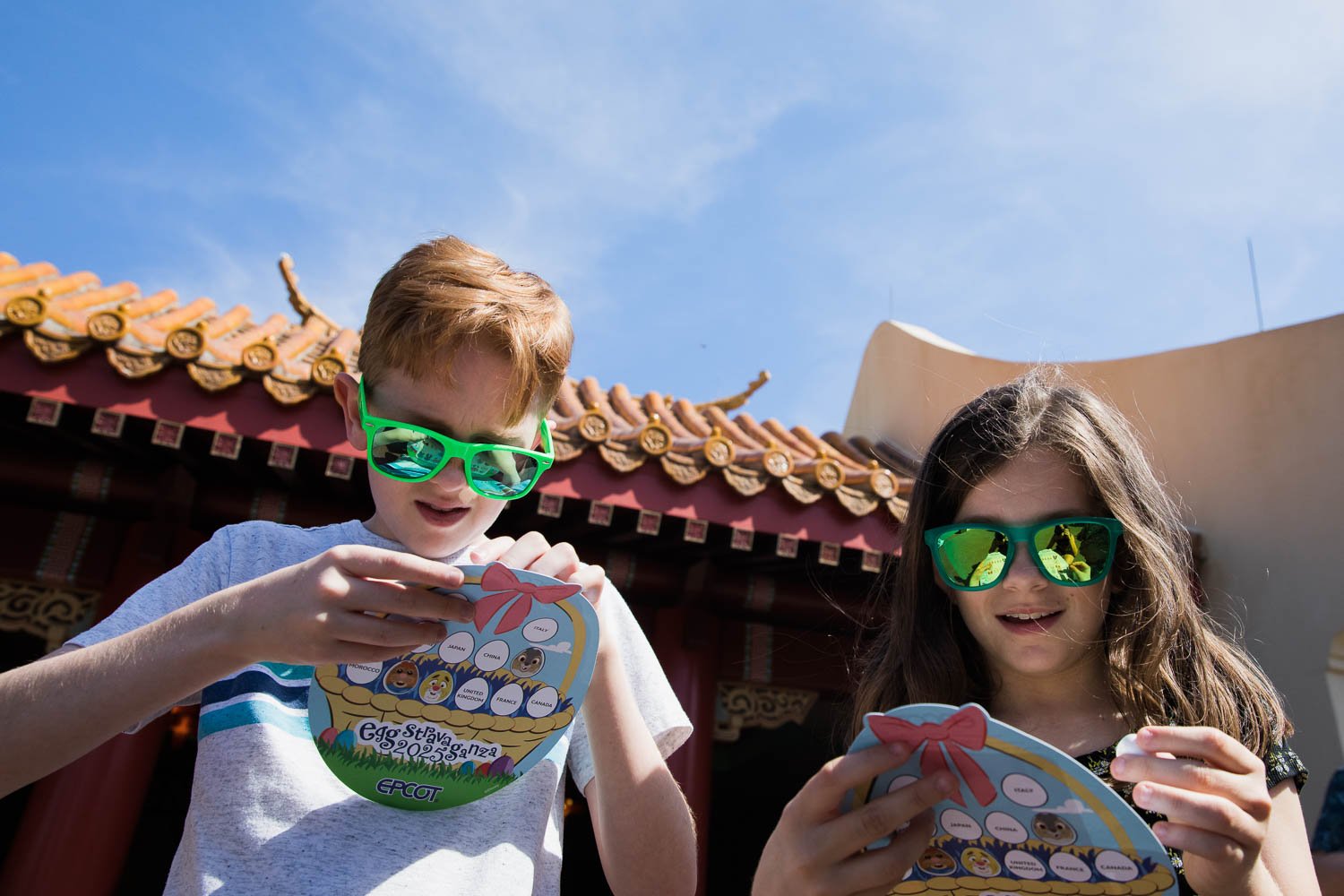 Kids place stickers on Epcot eggstravaganza map.