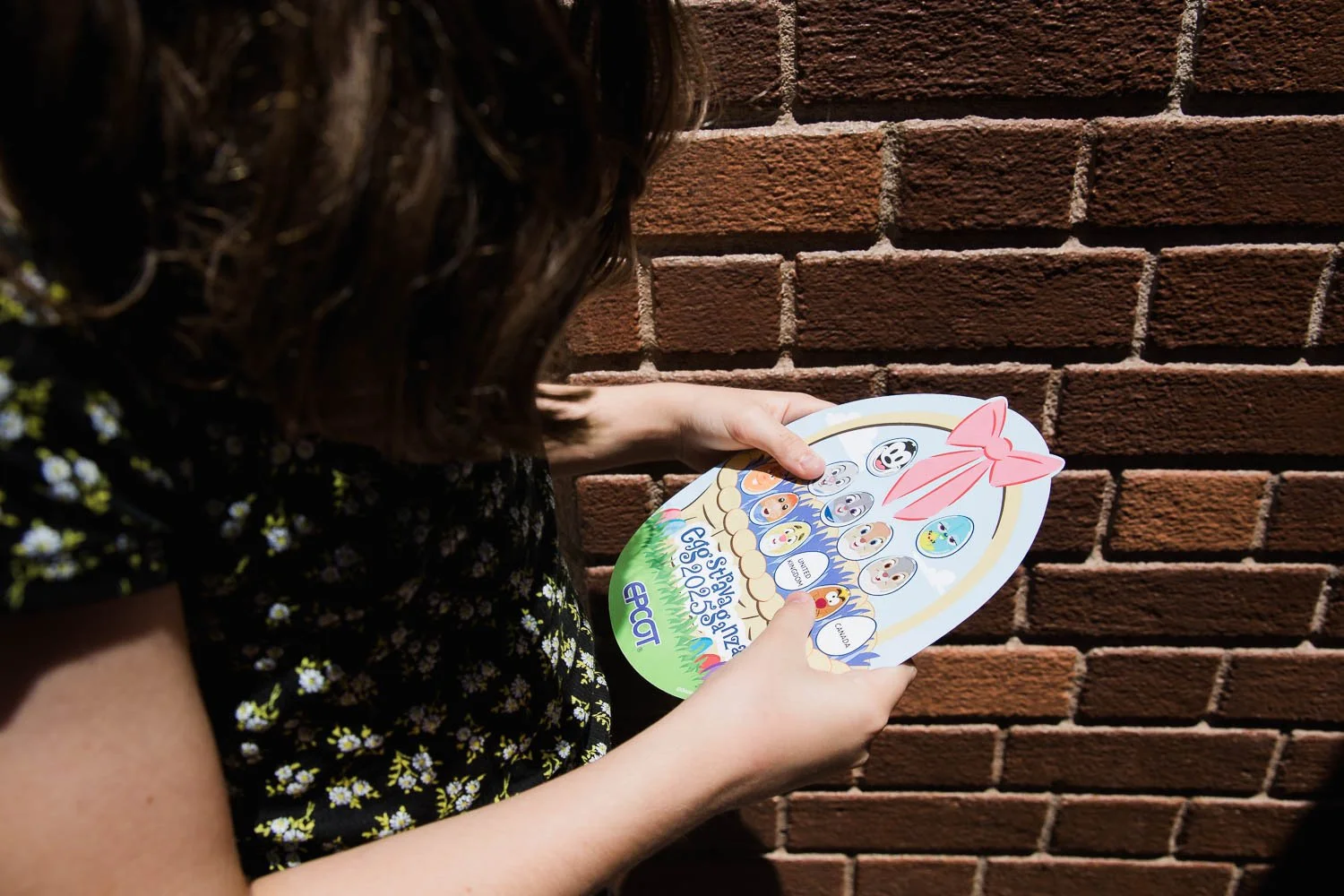 Girl looks at an Epcot Eggstravaganza map in World Showcase.