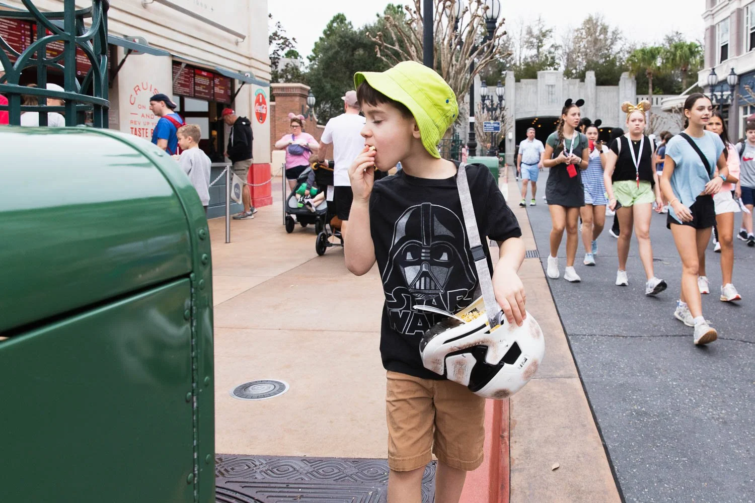 Boy eats popcorn out of stormtrooper bucket at Hollywood Studios.