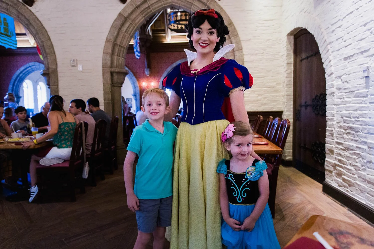 Siblings pose with Snow White at Akershus Royal Banquet Hall in Epcot.