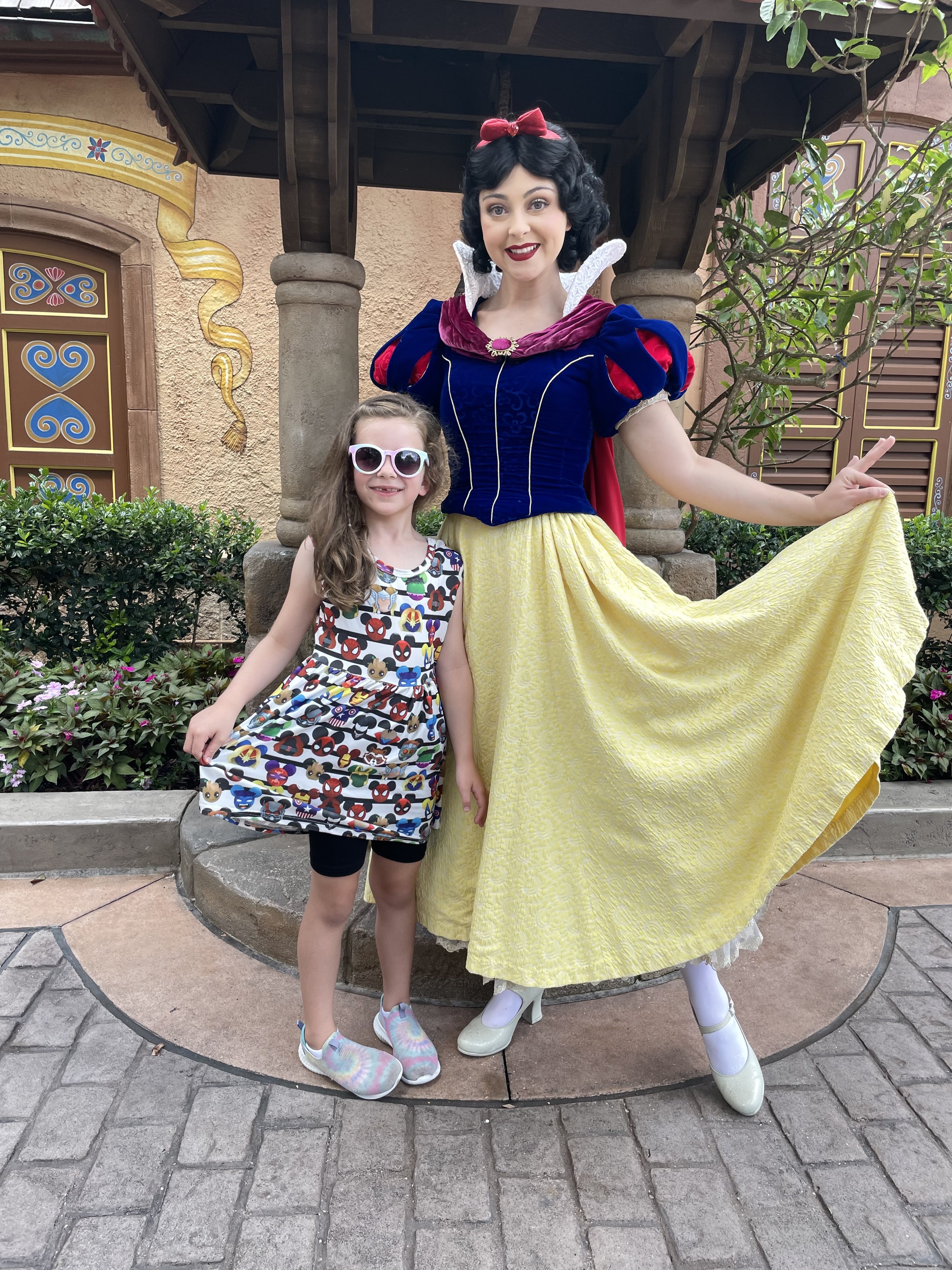 Girl posesw with Snow White at Epcot.