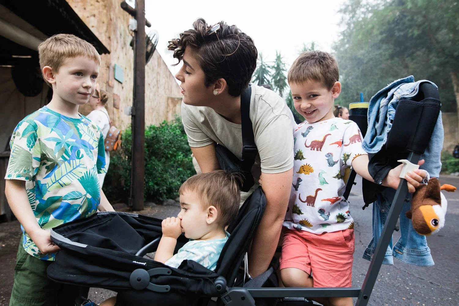 Mom situates three children in a stroller at the Animal Kingdom.