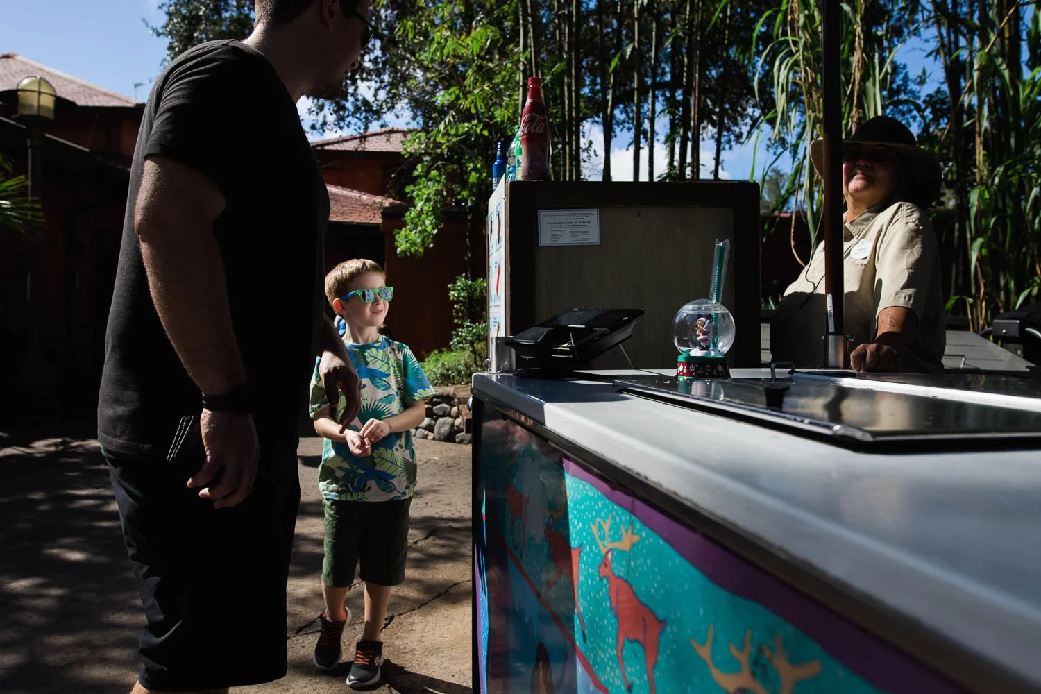 Father and son decide on a snack at an Animal Kingdom snack cart.