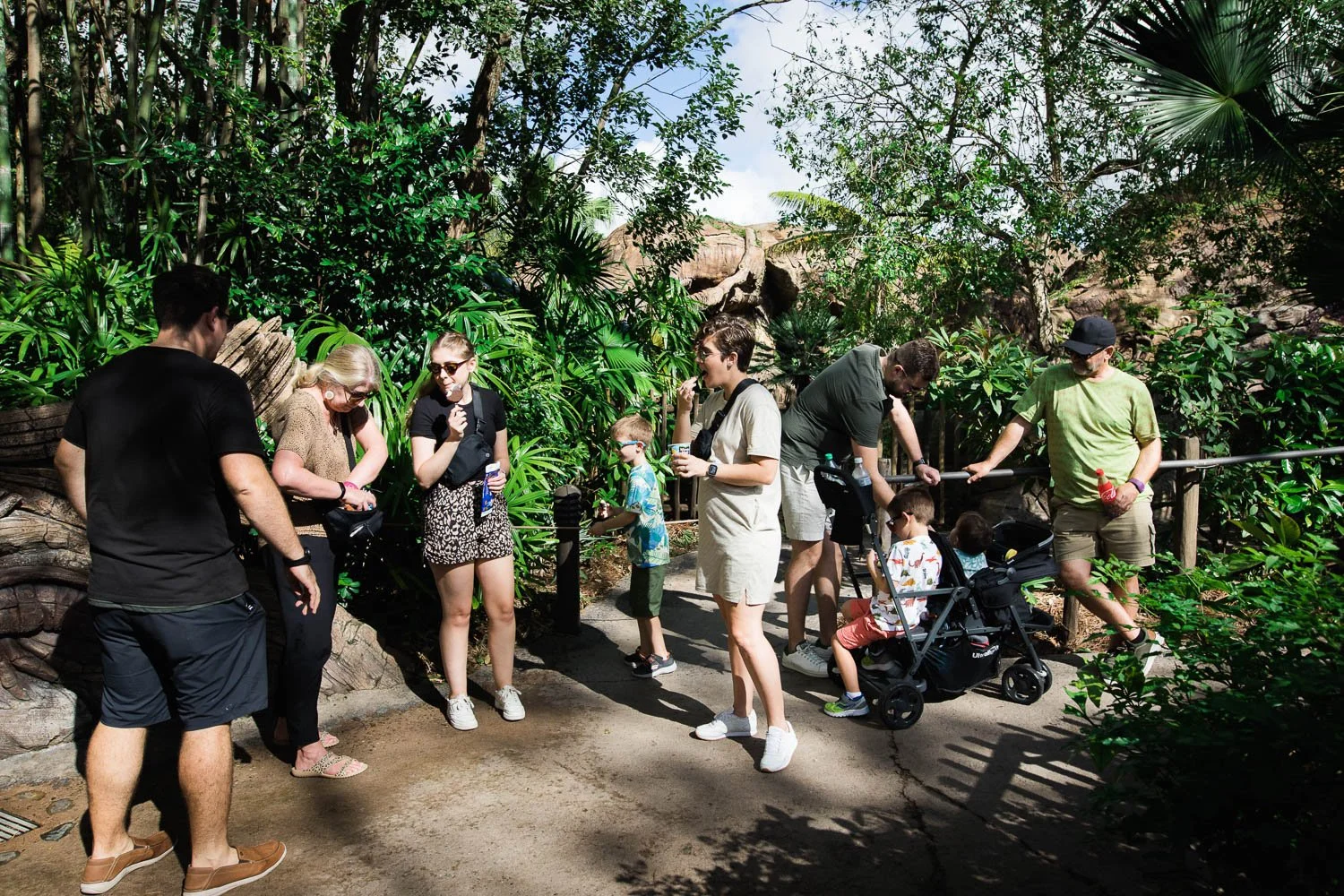 Family takes an ice cream snack break by the Tree of Life at the Animal Kingdom.